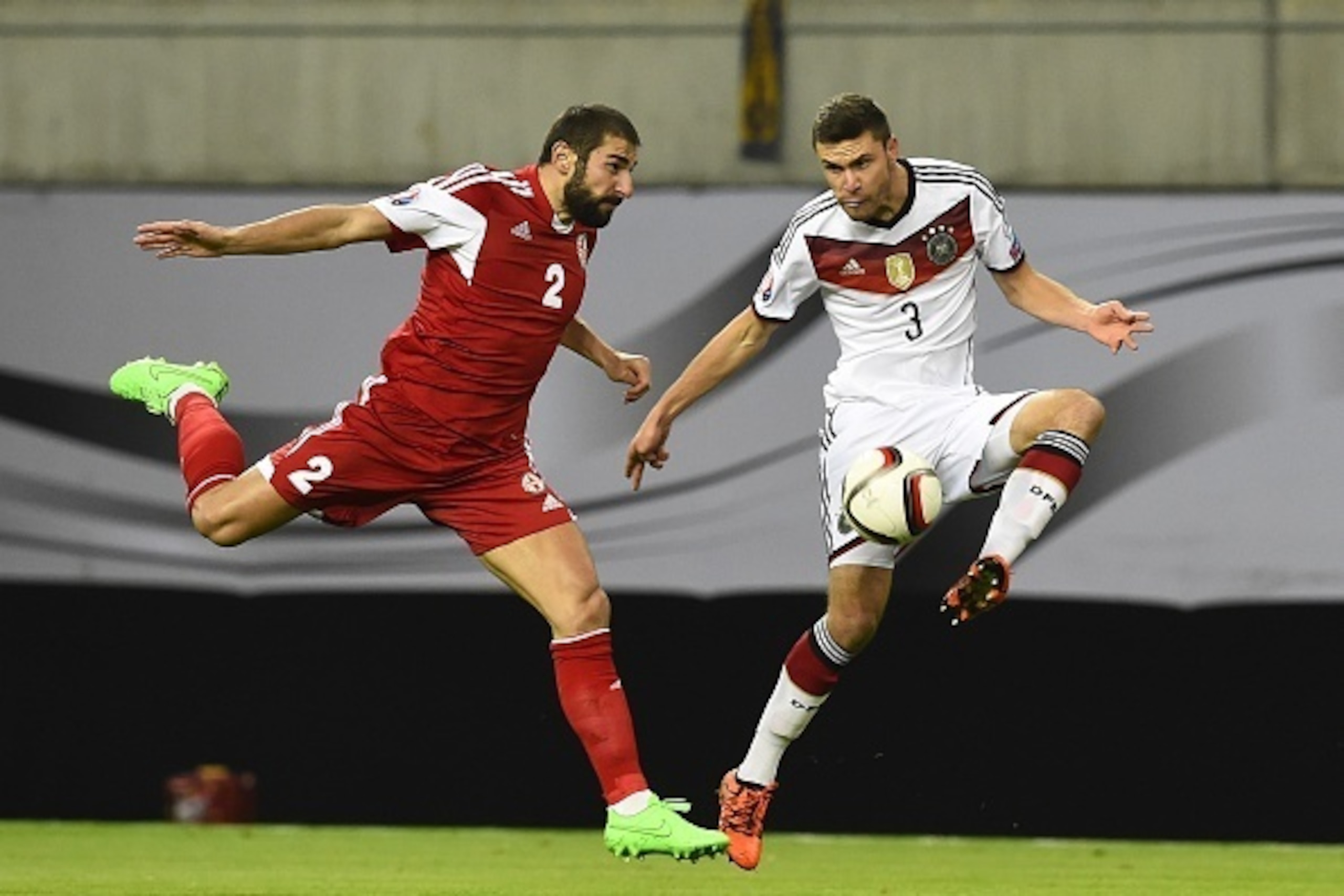 Germany's defender Jonas Hector (R) and Georgia's defender Ucha Lobzhanidze vie for the ball during the Euro 2016 Group D qualifying football match between Germany and Georgia in Leipzig, eastern Germany, on October 11, 2015. AFP PHOTO / TOBIAS SCHWARZ   