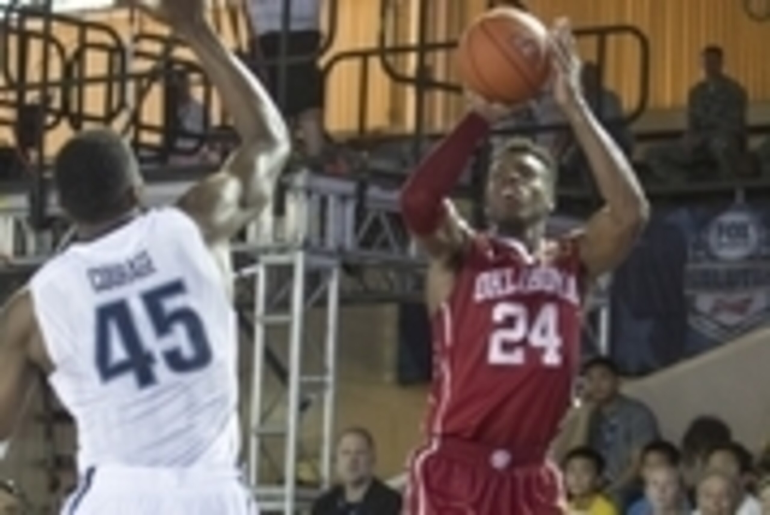 Dec 7, 2015; Honolulu, HI, USA; Oklahoma Sooners guard Buddy Hield (24)  makes a three point shot over Villanova Wildcats forward Darryl Reynolds (45) during the first half at Bloch Arena. Mandatory Credit: Marco Garcia-USA TODAY Sports