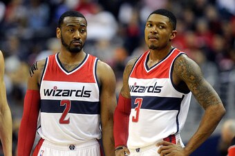 WASHINGTON, DC - APRIL 26:  John Wall #2 and Bradley Beal #3 of the Washington Wizards talk during the game against the Toronto Raptors during Game Four of the Eastern Conference Quarterfinals of the NBA playoffs at Verizon Center on April 26, 2015 in Was