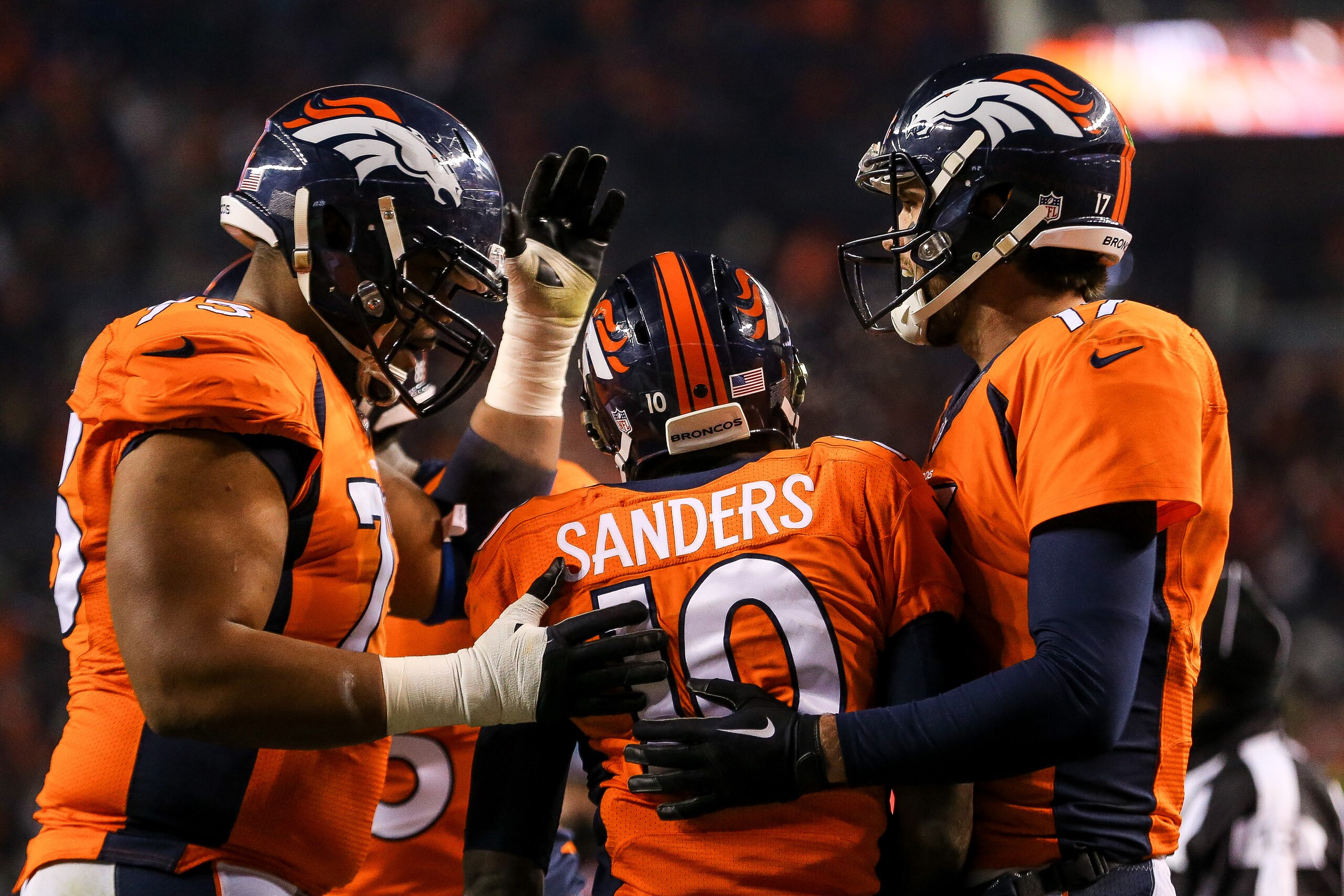 DENVER, CO - DECEMBER 28:  Wide receiver Emmanuel Sanders #10 of the Denver Broncos celebrates with quarterback Brock Osweiler #17 and Tyler Polumbus #76 after making a reception for an 8-yard touchdown against the Cincinnati Bengals in the third quarter