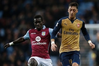 Aston Villa's Senegalese midfielder Idrissa Gueye (L) vies with Arsenal's German midfielder Mesut Ozil during the English Premier League football match between Aston Villa and Arsenal at Villa Park in Birmingham, central England on December 13, 2015. Arse