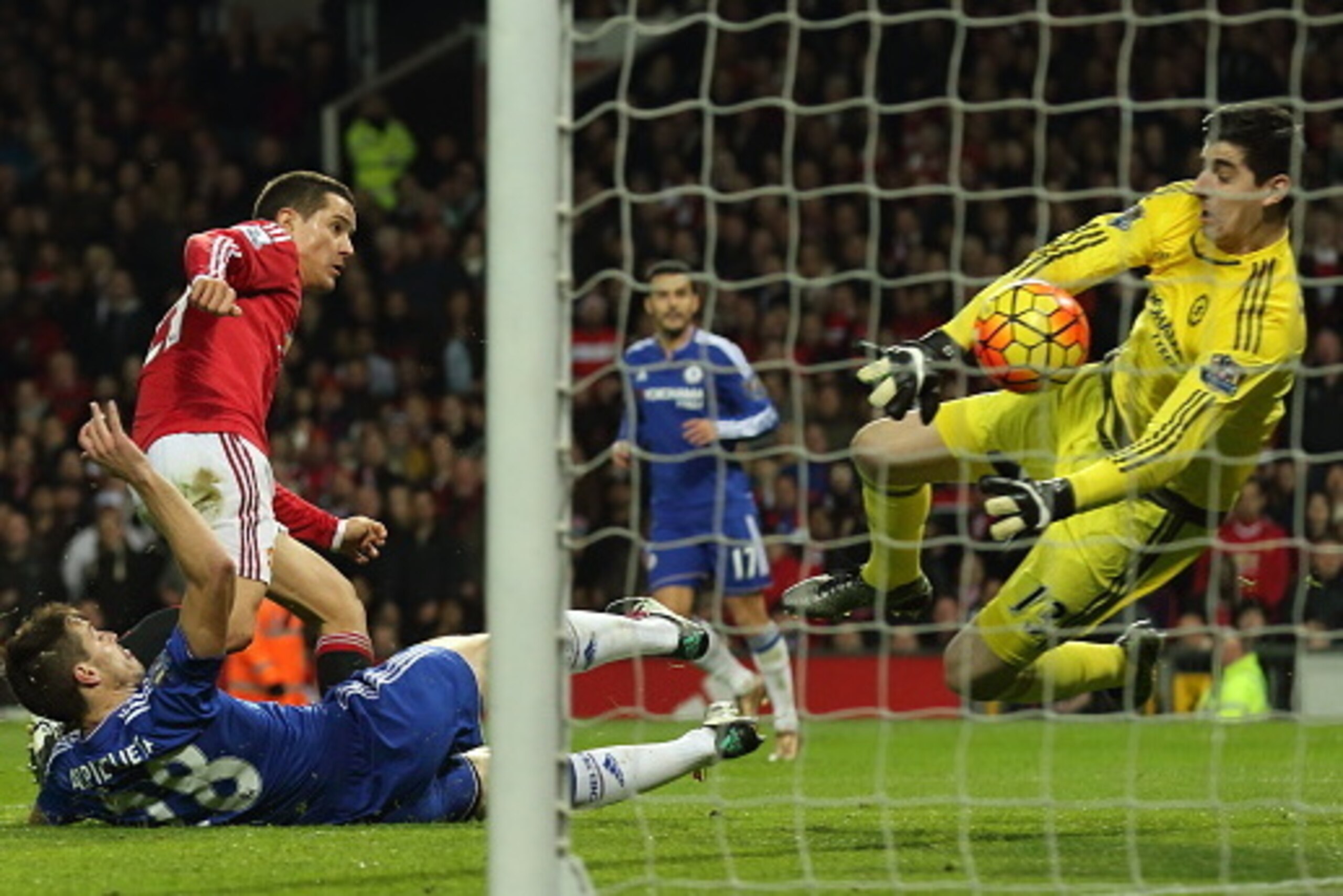 MANCHESTER, ENGLAND - DECEMBER 28:  Thibaut Courtois of Chelsea saves from Ander Herrera of Manchester United during the Barclays Premier League match between Manchester Untied and Chelsea at Old Trafford on December 28, 2015 in Manchester, England.  (Pho