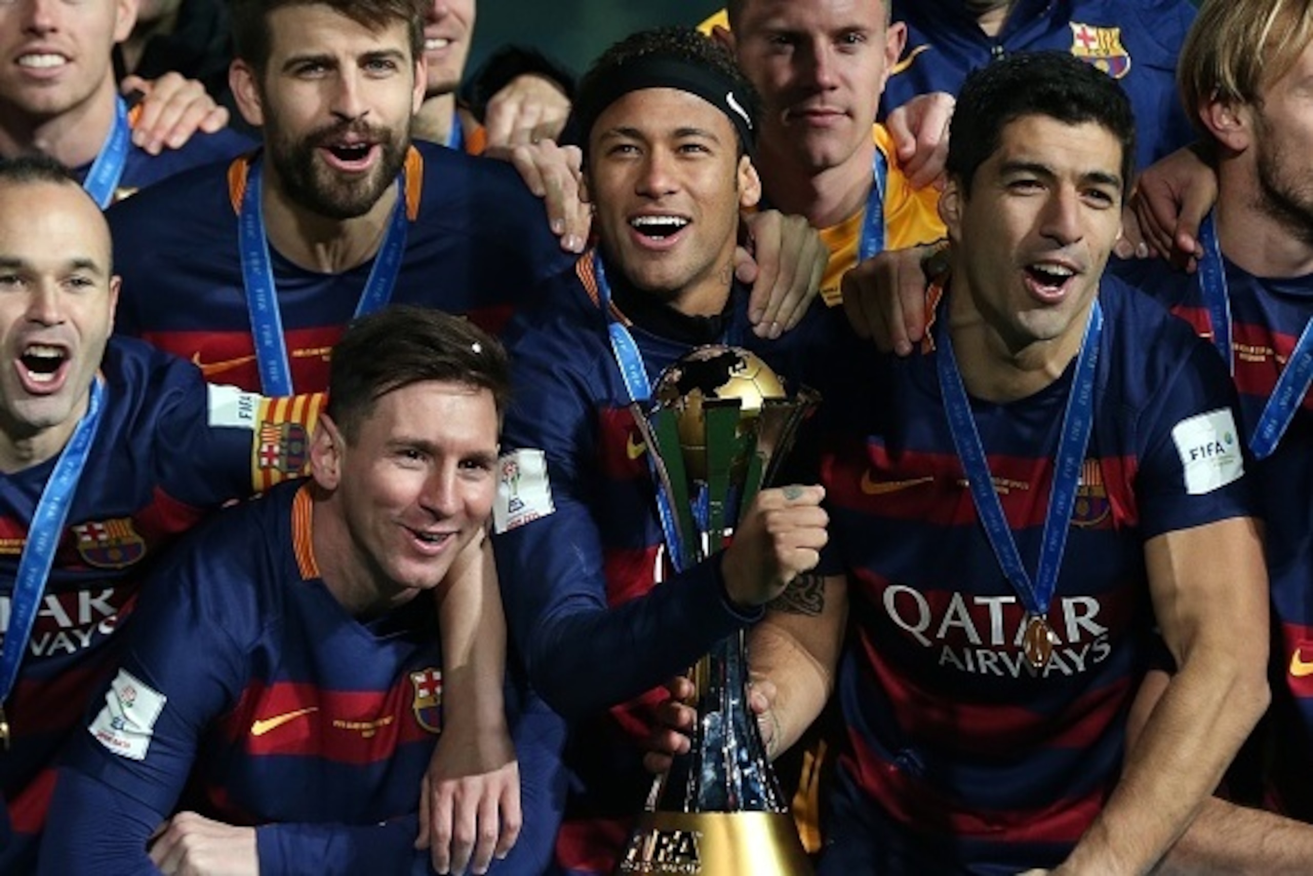YOKOHAMA, JAPAN - DECEMBER 20: (l-r) Lionel Messi, Neymar and Luis Suarez of Barcelona celebrate with the trophy following the FIFA Club World Cup Final match between River Plate and Barcelona at the International Stadium Yokohama on December 20, 2015 in 
