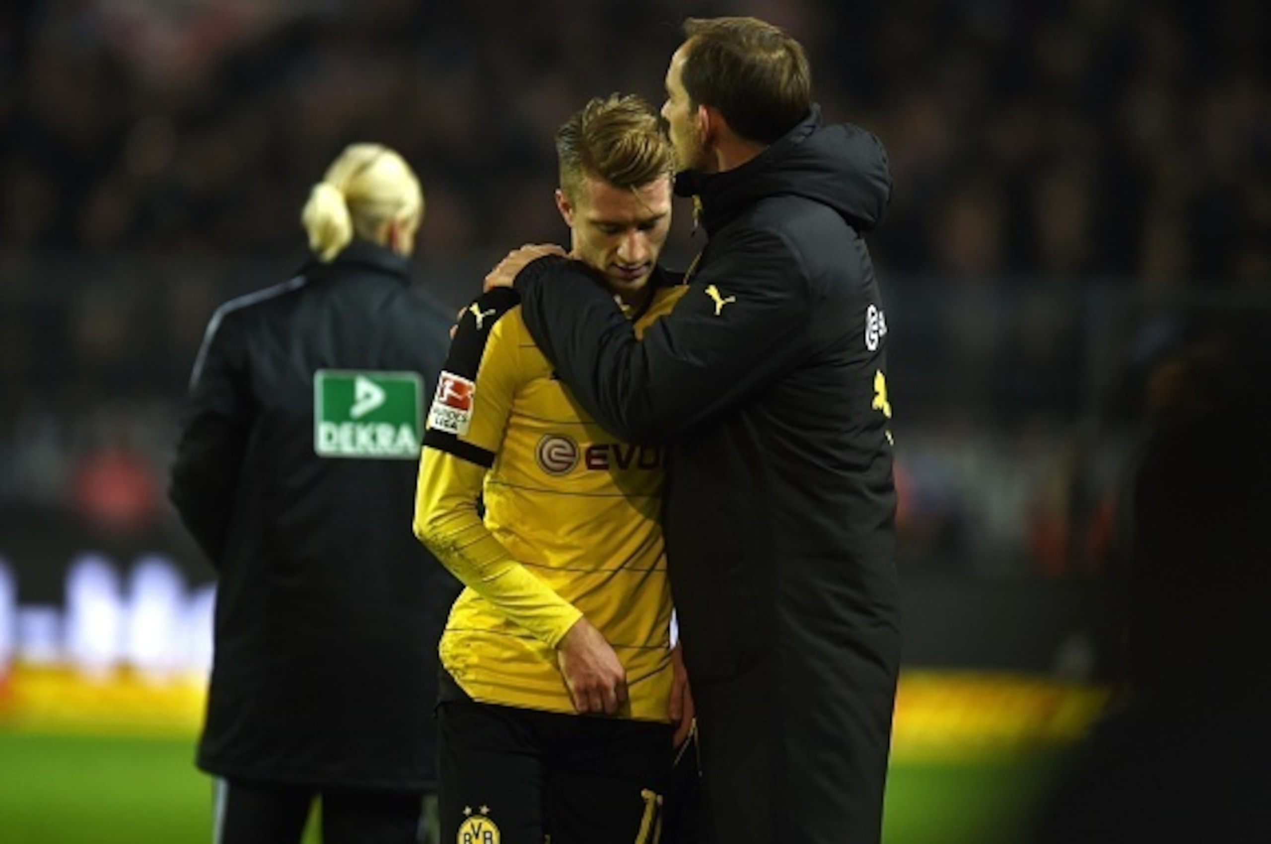 Dortmund's head coach Thomas Tuchel (R) talks to Dortmund's striker Marco Reus after his substitution during the German first division Bundesliga football match Borussia Dortmund vs Eintracht Frankfurt in Dortmund, western Germany, on December 13, 2015. A