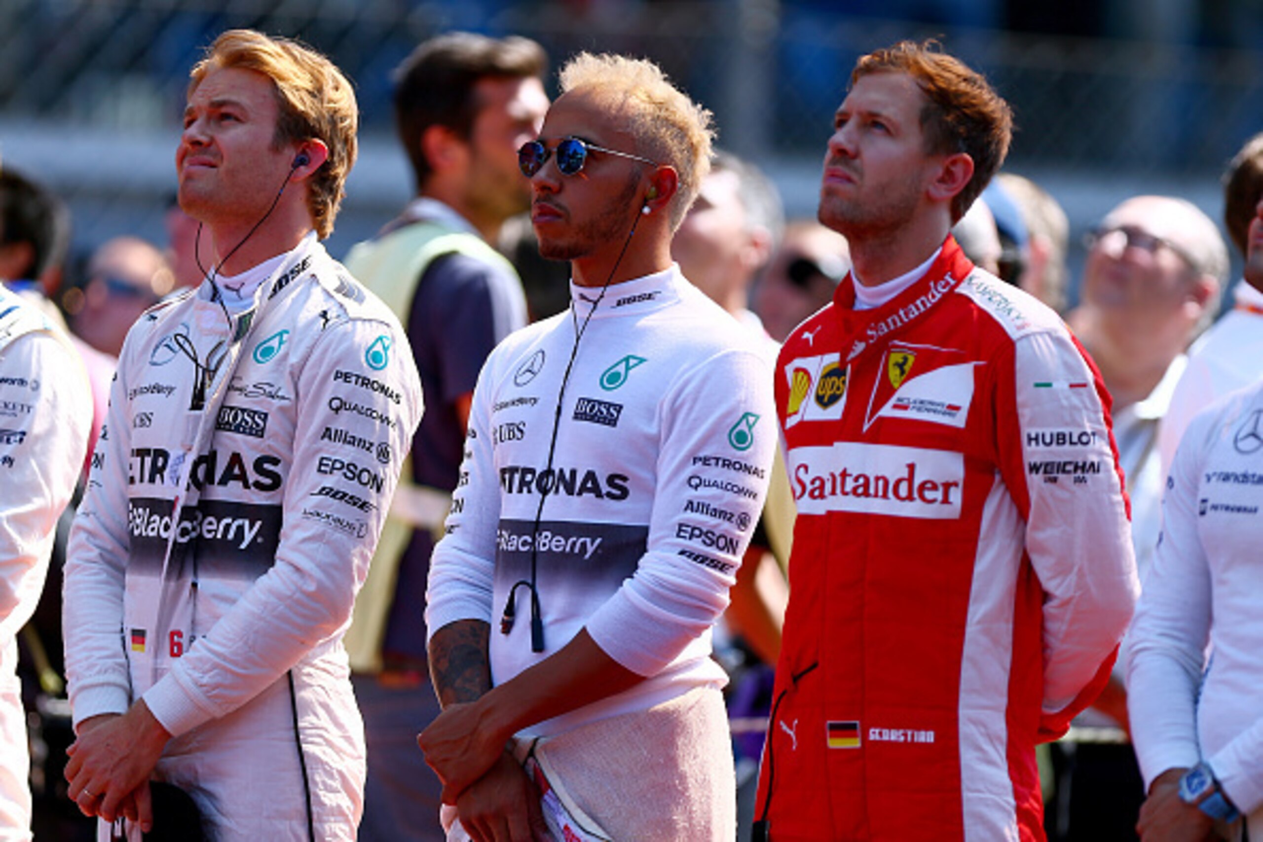 MONZA, ITALY - SEPTEMBER 06:  Nico Rosberg of Germany and Mercedes GP, Lewis Hamilton of Great Britain and Mercedes GP and Sebastian Vettel of Germany and Ferrari stand for the national anthem on the grid before the Formula One Grand Prix of Italy at Auto