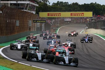 SAO PAULO, BRAZIL - NOVEMBER 15:  Nico Rosberg of Germany and Mercedes GP and Lewis Hamilton of Great Britain and Mercedes GP race into the first corner followed by the rest of the field during the Formula One Grand Prix of Brazil at Autodromo Jose Carlos