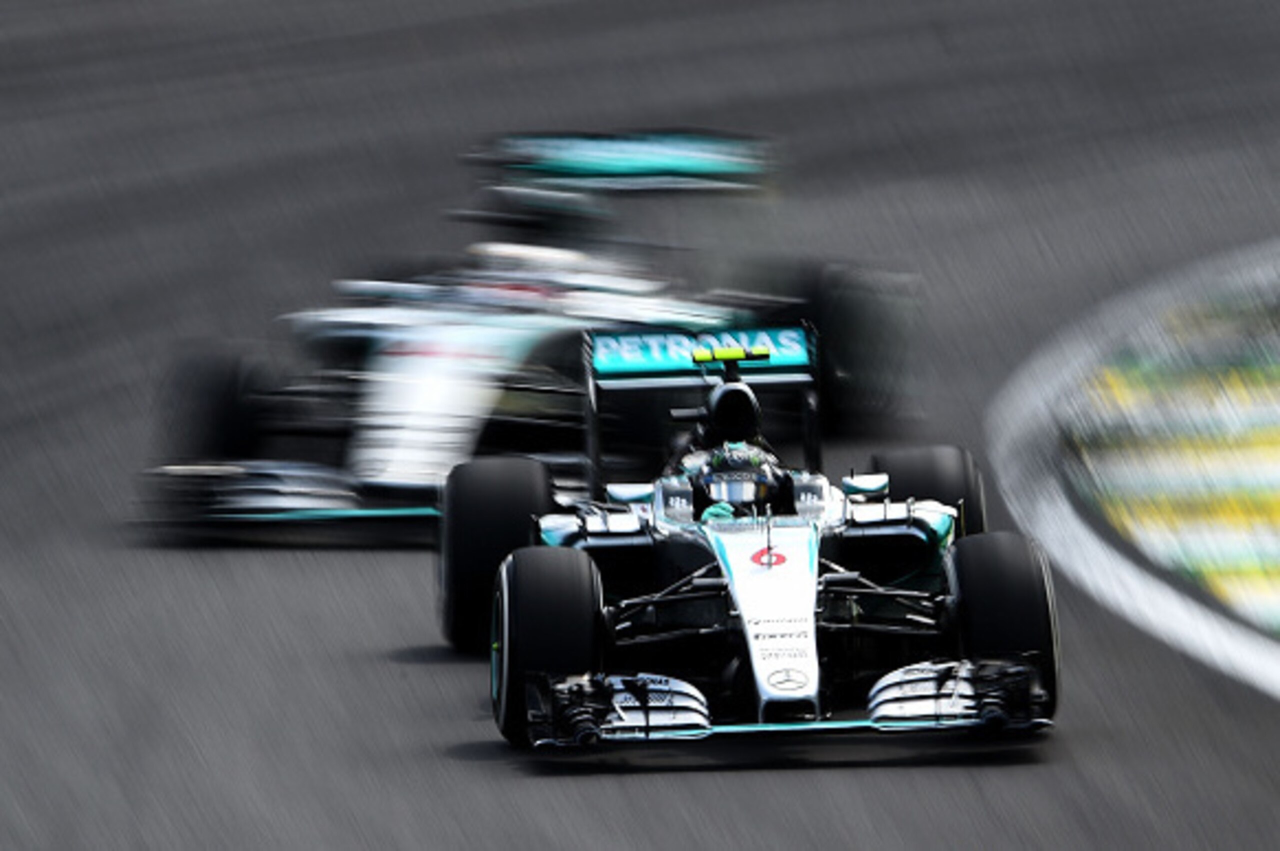 SAO PAULO, BRAZIL - NOVEMBER 15:  Nico Rosberg of Germany and Mercedes GP drives infront of Lewis Hamilton of Great Britain and Mercedes GP during the Formula One Grand Prix of Brazil at Autodromo Jose Carlos Pace on November 15, 2015 in Sao Paulo, Brazil