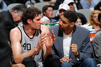 SAN ANTONIO, TX - DECEMBER 26:  Boban Marjanovic #40 of the San Antonio Spurs and Tim Duncan #21 of the San Antonio Spurs talk during the game against the Denver Nuggets on December 26, 2015 at the AT&T Center in San Antonio, Texas. NOTE TO USER: User exp