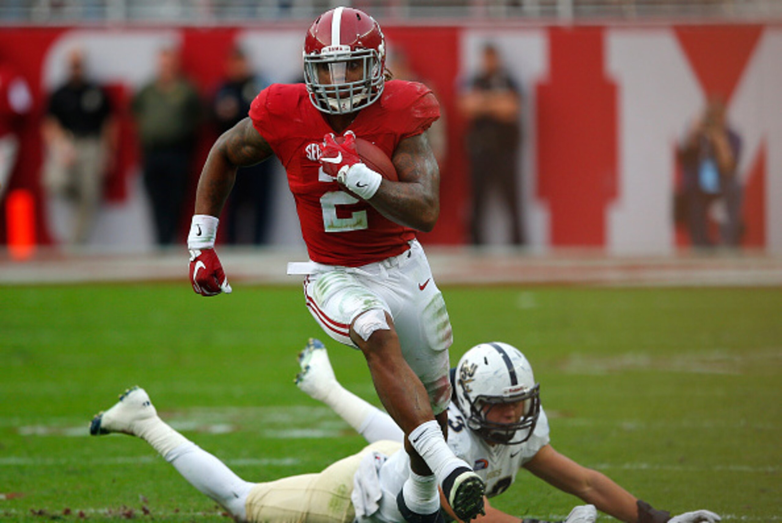 TUSCALOOSA, AL - NOVEMBER 21:  Derrick Henry #2 of the Alabama Crimson Tide rushes past Zane Cruz #43 of the Charleston Southern Buccaneers at Bryant-Denny Stadium on November 21, 2015 in Tuscaloosa, Alabama.  (Photo by Kevin C. Cox/Getty Images)