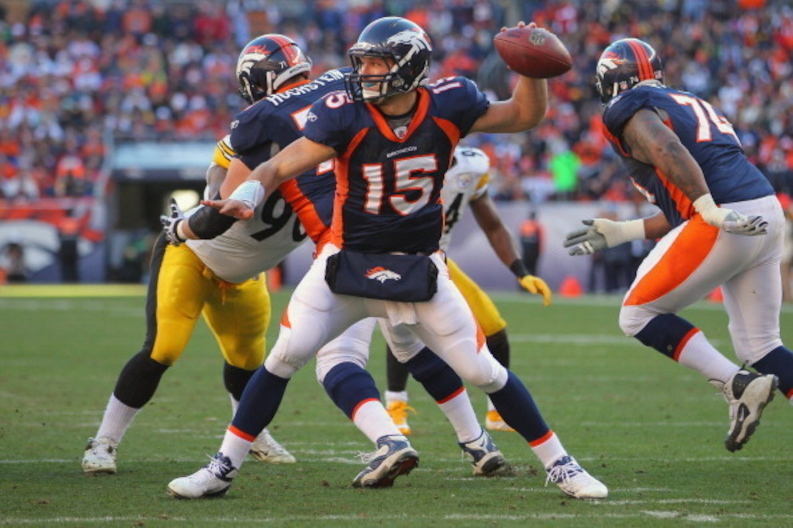 DENVER, CO - JANUARY 08:  Tim Tebow #15 of the Denver Broncos delivers a pass against the Pittsburgh Steelers at Sports Authority Field at Mile High on January 8, 2012 in Denver, Colorado.  (Photo by Doug Pensinger/Getty Images)