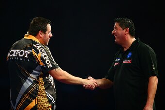 LONDON, ENGLAND - DECEMBER 29:  Adrian Lewis of England (L) shakes hands with Mensur Suljovic of Austria (R) after victory in their third round match on Day Eleven of the 2016 William Hill PDC World Darts Championships at Alexandra Palace on December 29, 