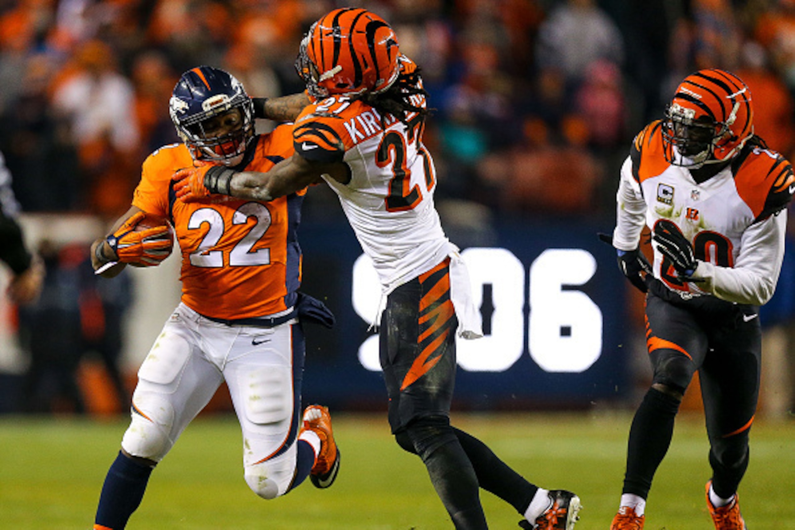 DENVER, CO - DECEMBER 28:  Running back C.J. Anderson #22 of the Denver Broncos is tackled by cornerback Dre Kirkpatrick #27 of the Cincinnati Bengals as free safety Reggie Nelson #20 backs up the play during a game at Sports Authority Field at Mile High 