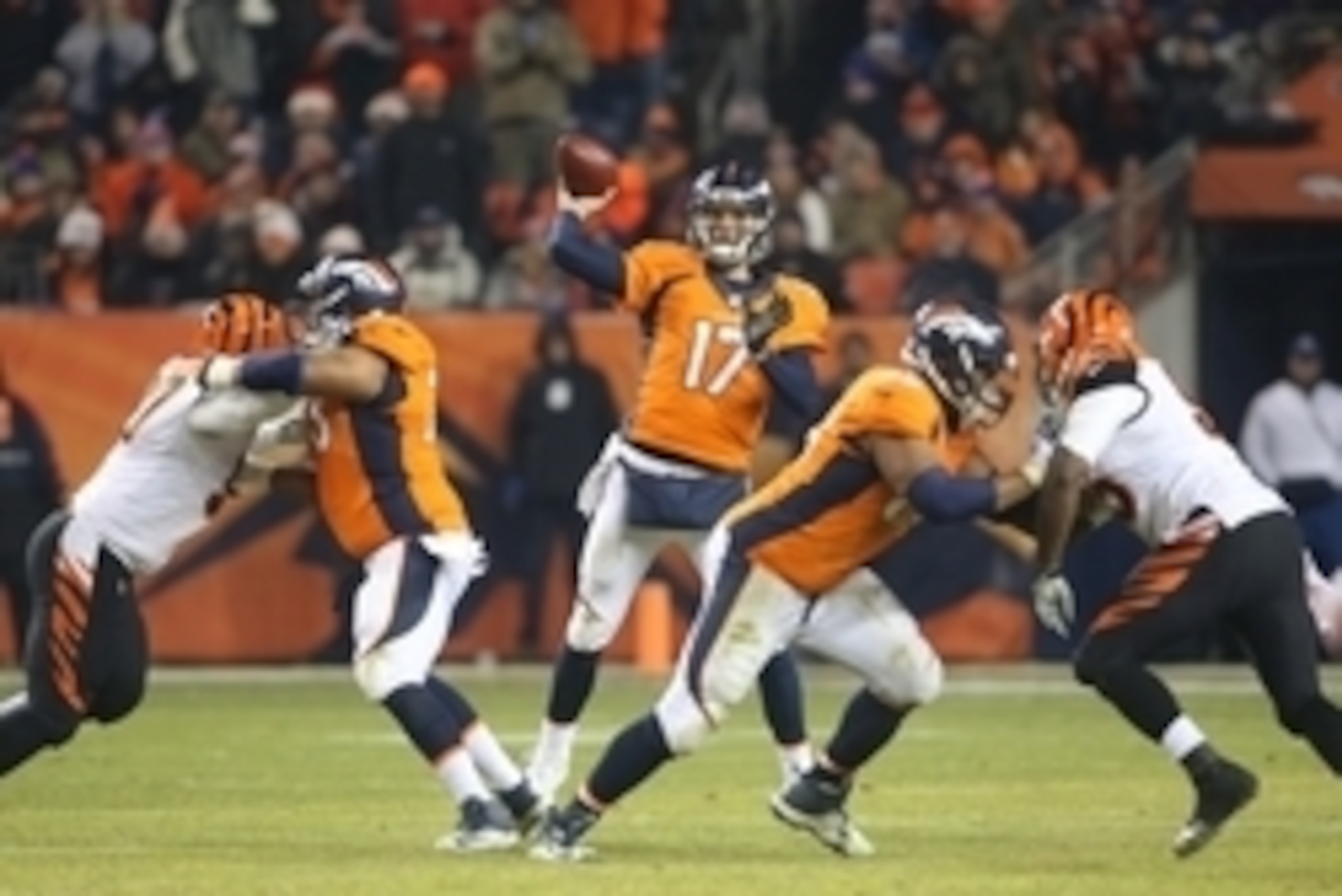 Dec 28, 2015; Denver, CO, USA; Denver Broncos quarterback Brock Osweiler (17) throws a pass during the second half against the Cincinnati Bengals at Sports Authority Field at Mile High.  The Broncos won 20-17 in overtime. Mandatory Credit: Chris Humphreys