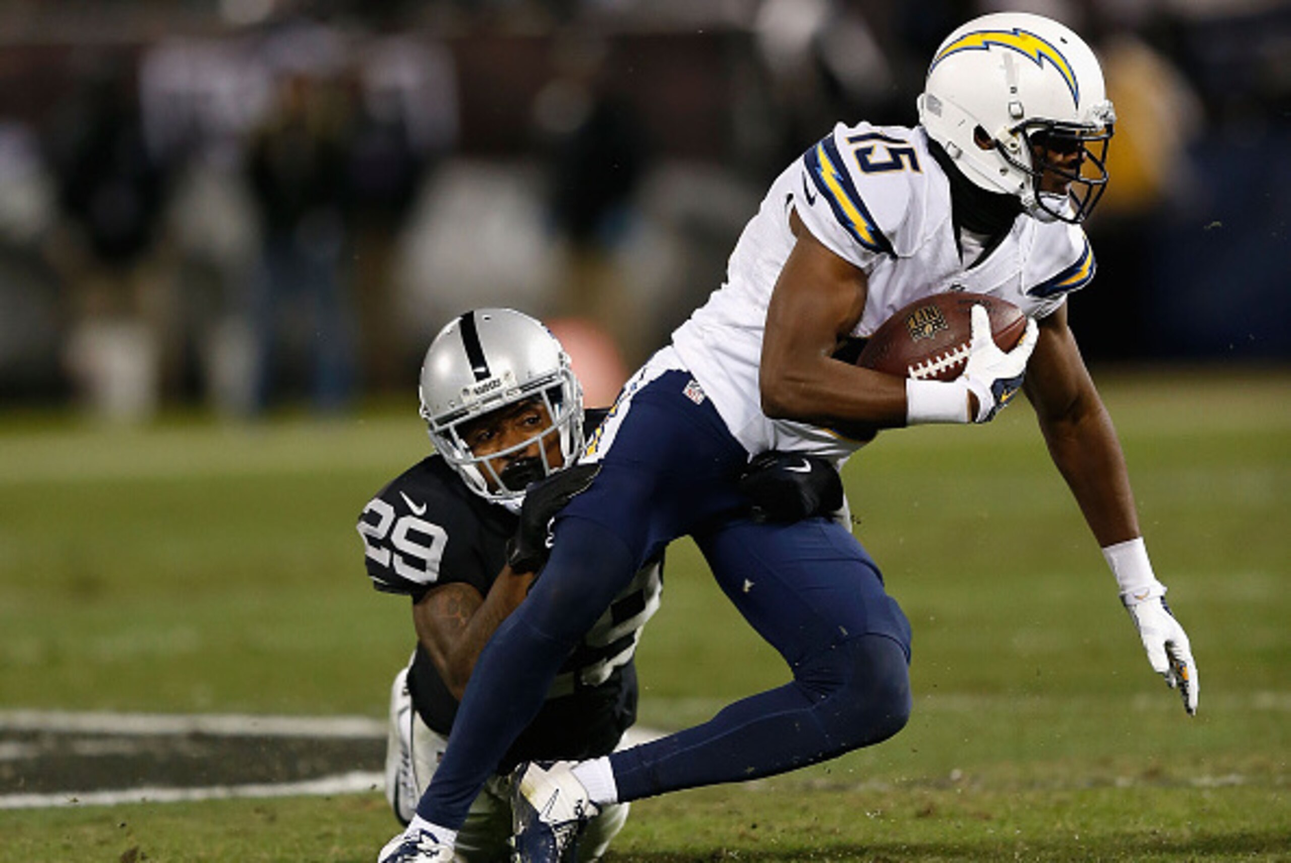 OAKLAND, CA - DECEMBER 24: Wide receiver Dontrelle Inman #15 of the San Diego Chargers is tackled by cornerback David Amerson #29 of the Oakland Raiders in the second quarter at O.co Coliseum on December 24, 2015 in Oakland, California. (Photo by Lachlan 