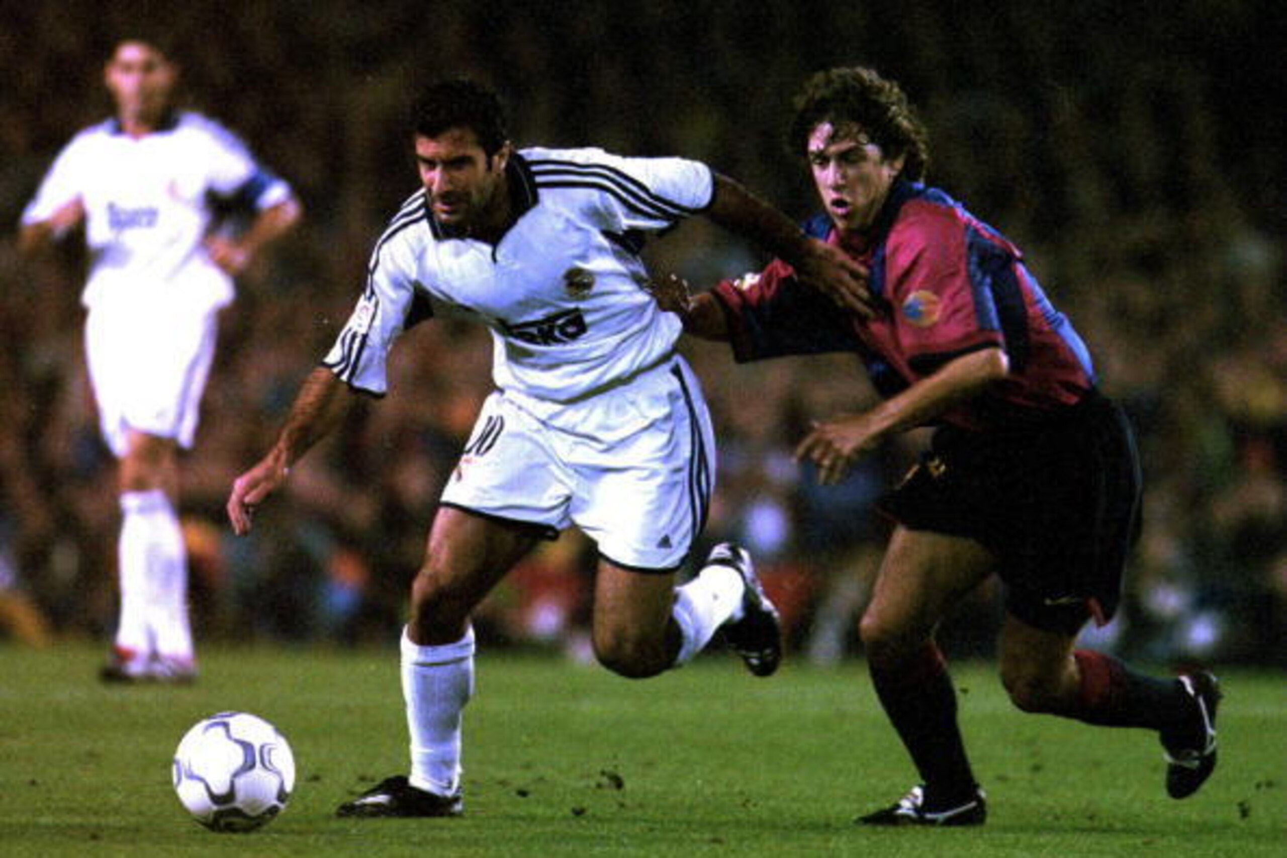 21 Oct 2000: Luis Figo of Real Madrid gets away from Carles Puyol of Barcelona during the Spanish Primera Liga match between Barcelona and Real Madrid at the Nou Camp in Barcelona, Spain. Mandatory Credit: Allsport/ALLSPORT