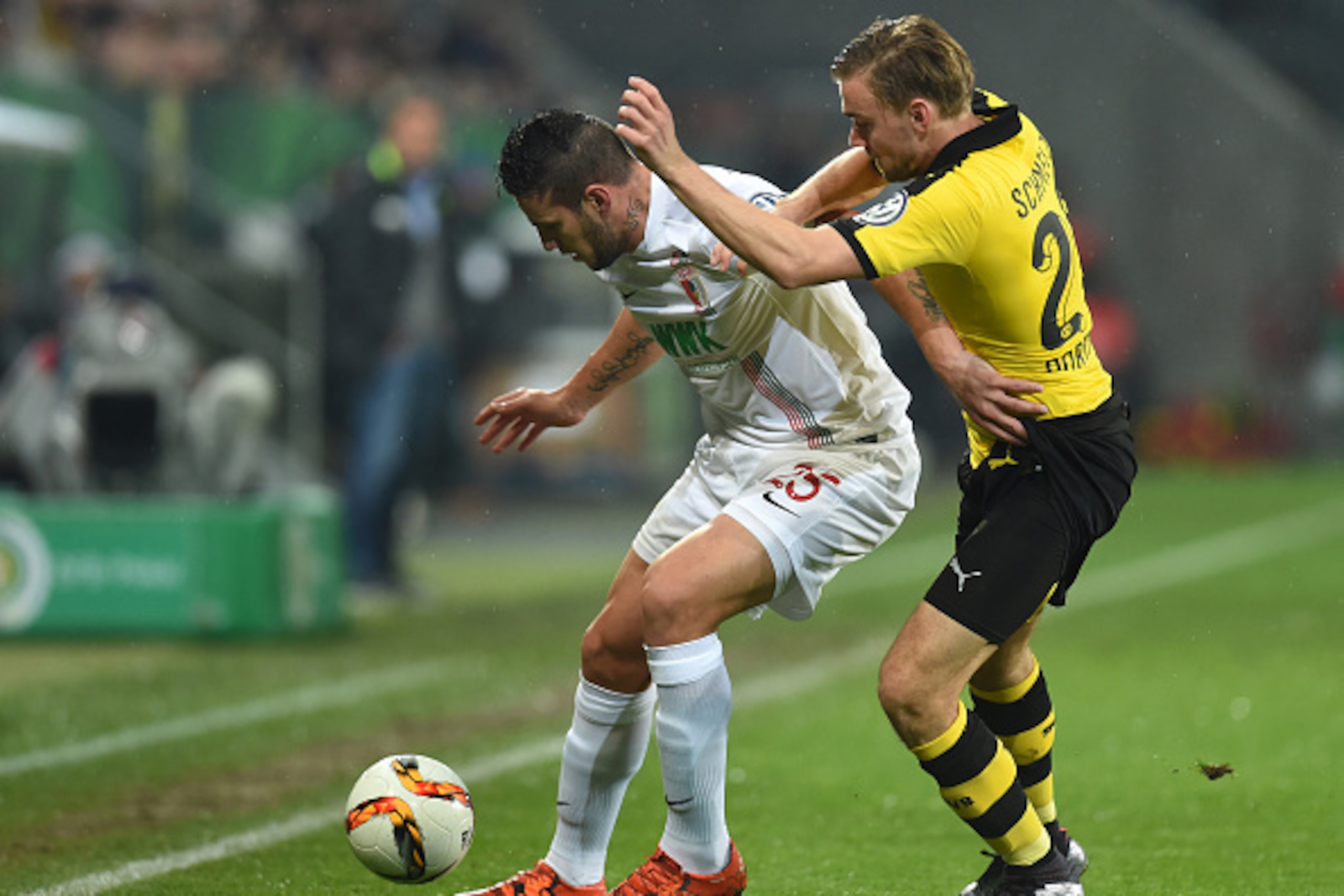 (L-R) Augsburg's Argentinian striker Raul Bobadilla and Dortmund's defender Marcel Schmelzer vie during the German Cup DFB Pokal third round match between Borussia Dortmund and FC Augsburg in Augsburg on December 16, 2015.  / AFP / Christof STACHE / RESTR