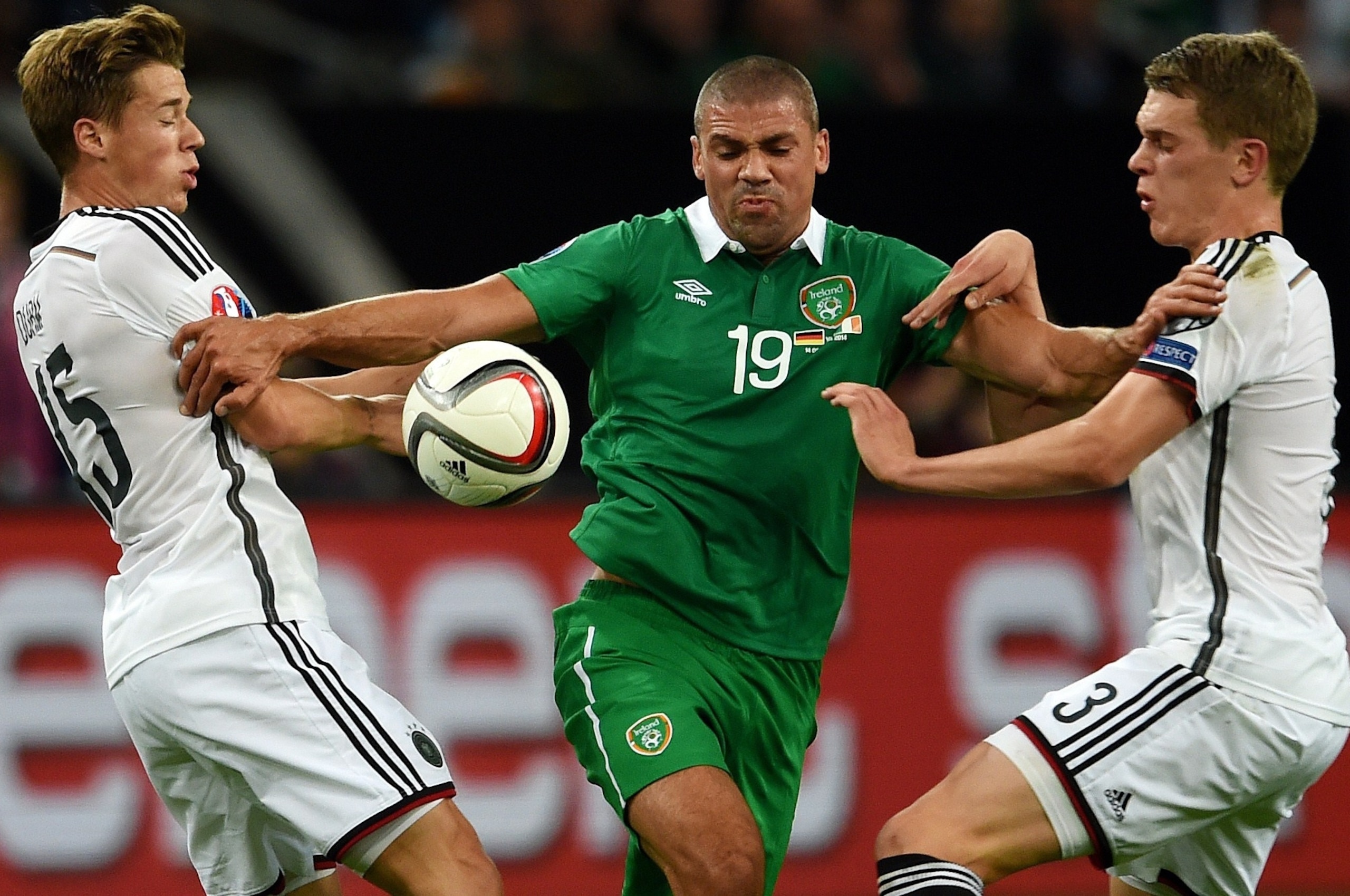 Germany's defender Matthias Ginter (R), Germany's defender Erik Durm (L) pressure Ireland 's Jon Walters for the ball during the UEFA Euro 2016 Group D qualifying football match Germany vs Republic of Ireland in Gelsenkirchen, western Germany on October 1