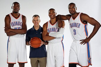 OKLAHOMA CITY, OK - SEPTEMBER 28:  Kevin Durant #35, head coach Billy Donovan, Russell Westbrook #0 and Serge Ibaka #9 of the Oklahoma City Thunder pose for a portrait during 2015 NBA Media Day on September 28, 2015 at the Thunder Events Center in Edmond,