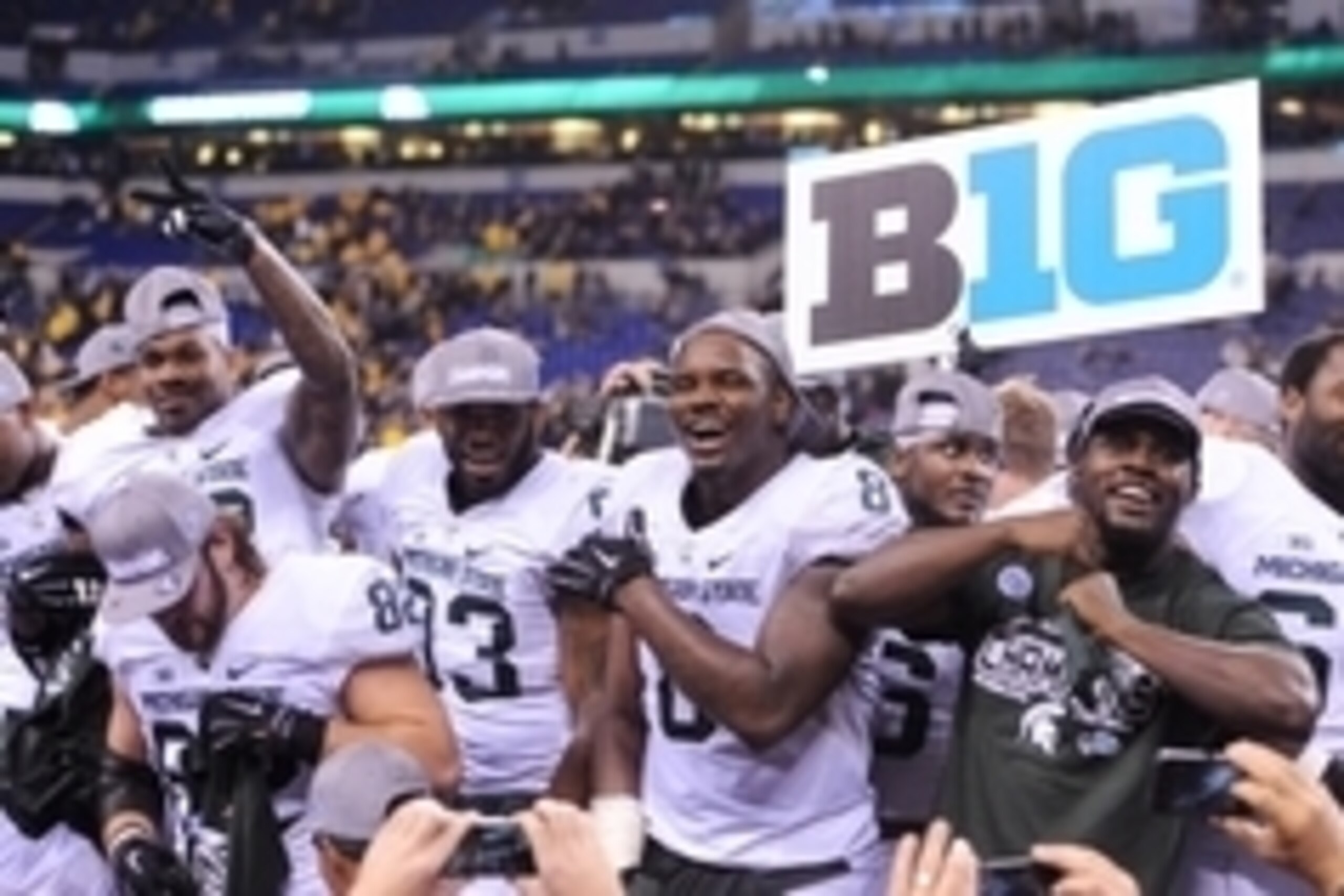 Dec 5, 2015; Indianapolis, IN, USA; Michigan State Spartans defensive lineman Lawrence Thomas (8) and his teammates celebrate on the stage after the game against the Iowa Hawkeyes in the Big Ten Conference football championship game at Lucas Oil Stadium. 