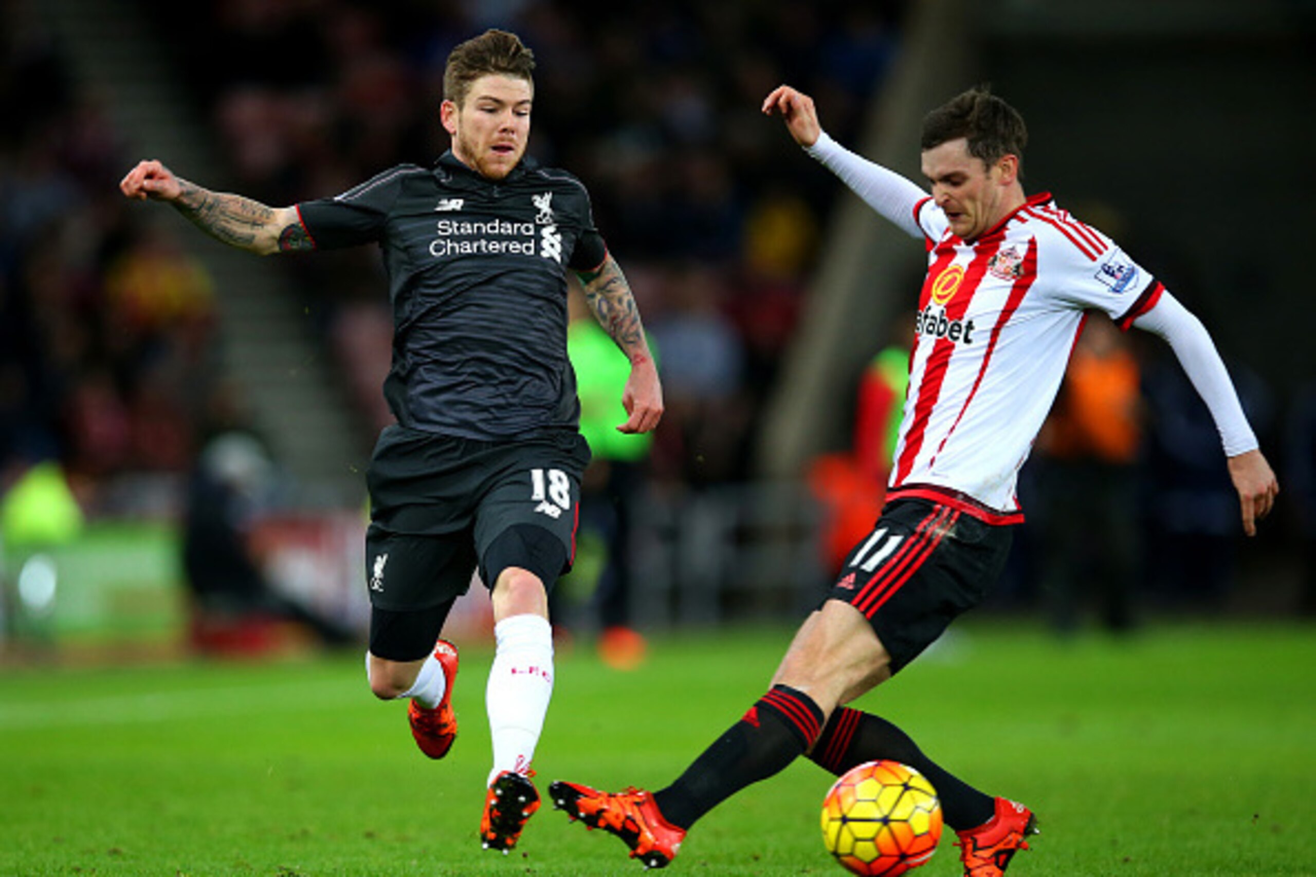 SUNDERLAND, ENGLAND - DECEMBER 30: Alberto Moreno of Liverpool battles for the ball with Adam Johnson of Sunderland during the Barclays Premier League match between Sunderland and Liverpool at Stadium of Light on December 30, 2015 in Sunderland, England. SUNDERLAND, ENGLAND - DECEMBER 30: Alberto Moreno of Liverpool battles for the ball with Adam Johnson of Sunderland during the Barclays Premier League match between Sunderland and Liverpool at Stadium of Light on December 30, 2015 in Sunderland, England.