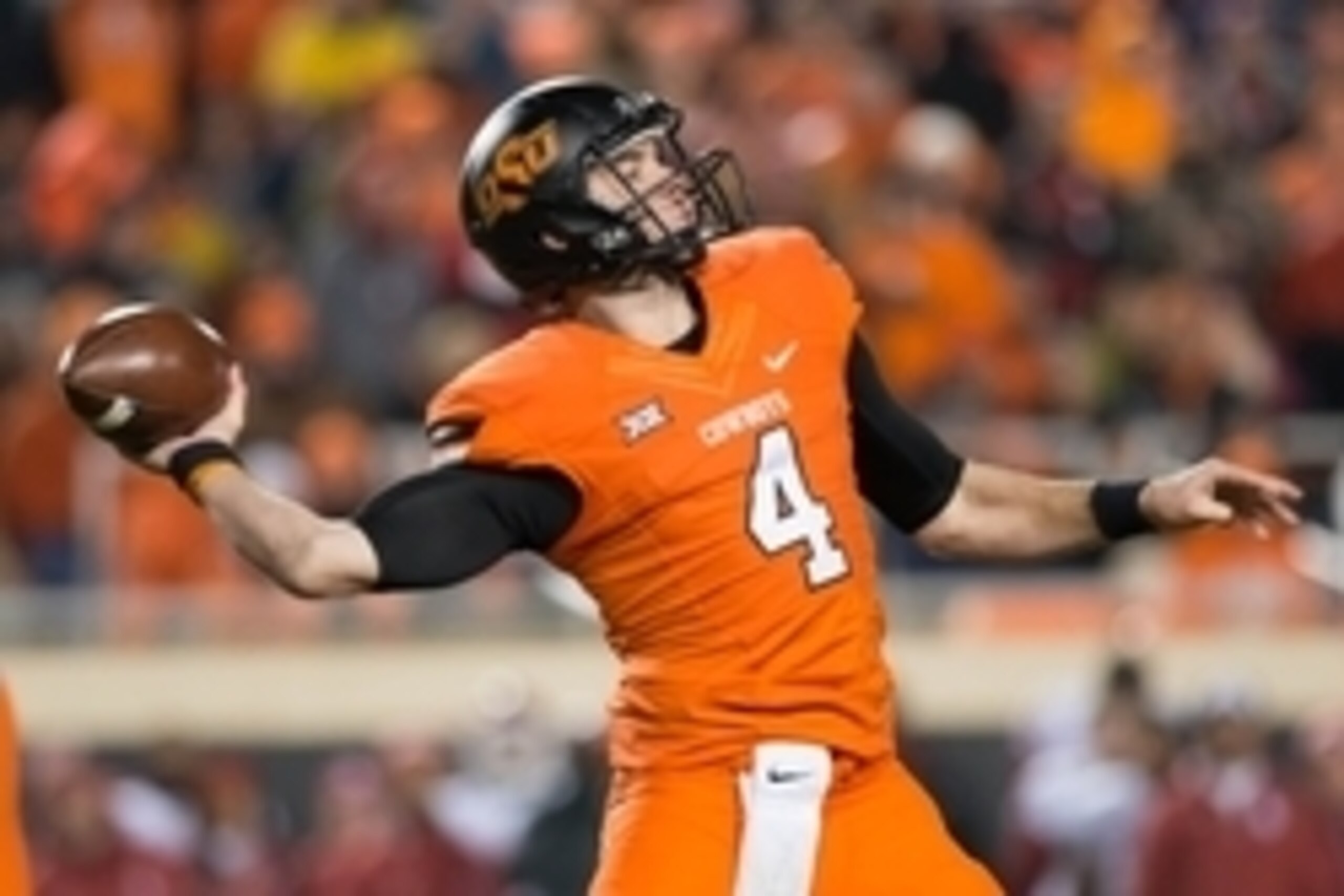 Nov 28, 2015; Stillwater, OK, USA; Oklahoma State Cowboys quarterback J.W. Walsh (4) looks to pass against the Oklahoma Sooners during the second quarter at Boone Pickens Stadium. Oklahoma won 58-23. Mandatory Credit: Rob Ferguson-USA TODAY Sports