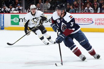 DENVER, CO - DECEMBER 09:  Francois Beauchemin #32 of the Colorado Avalanche controls the puck against David Perron #57 of the Pittsburgh Penguins at Pepsi Center on December 9, 2015 in Denver, Colorado. The Penguins defeated the Avalanche 4-2.  (Photo by