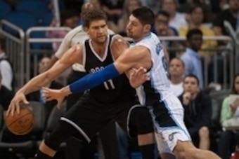 Dec 30, 2015; Orlando, FL, USA; Brooklyn Nets center Brook Lopez (11) defended by Orlando Magic center Nikola Vucevic (9) at Amway Center. The Magic won 93-100. Mandatory Credit: Jeff Griffith-USA TODAY Sports