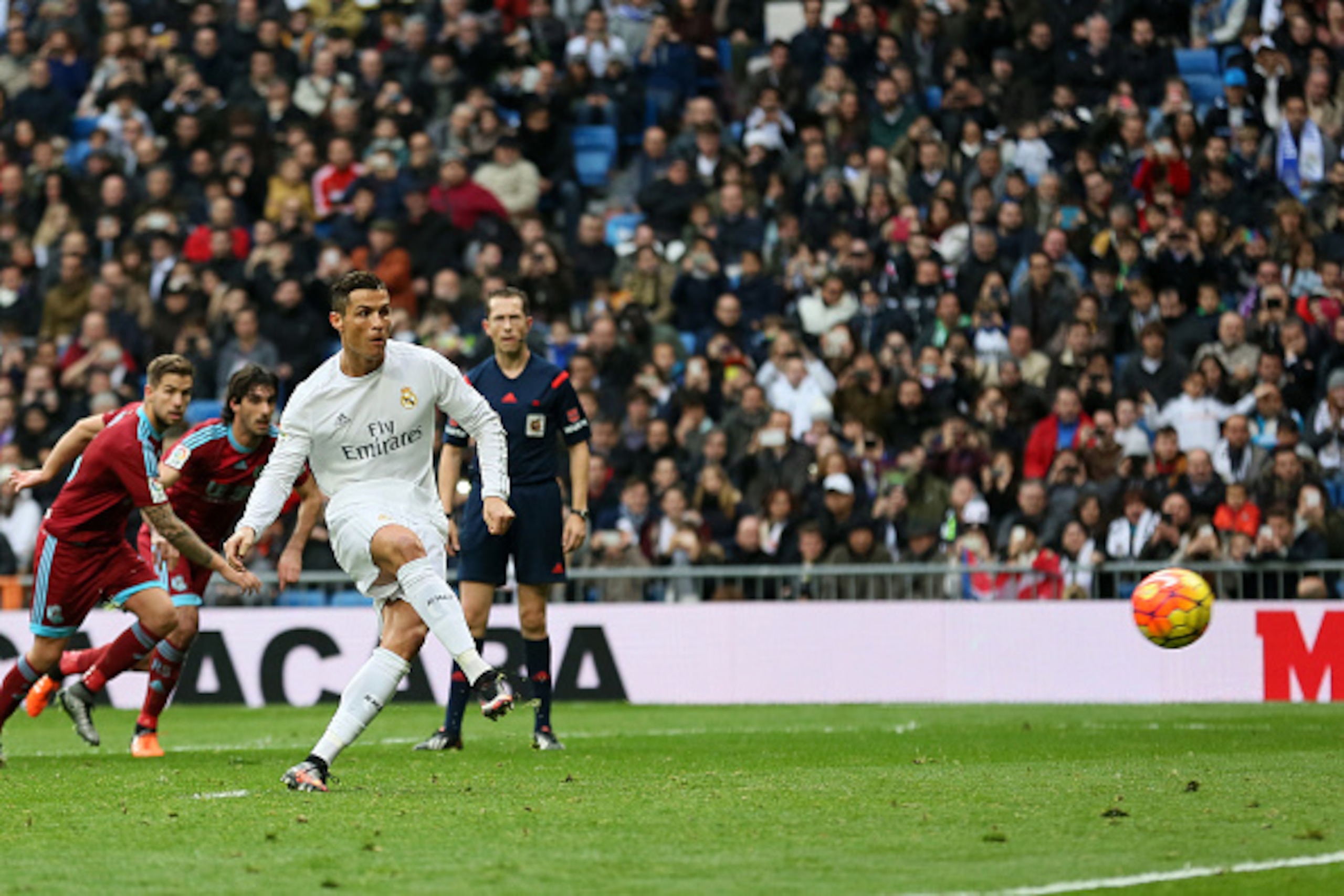 Real Madrid's Portuguese forward Cristiano Ronaldo (2ndR) scores on a penalty during the Spanish league football match Real Madrid CF vs Real Sociedad de Futbol at the Santiago Bernabeu stadium in Madrid on December 30, 2015. AFP PHOTO/ CESAR MANSO / AF Real Madrid's Portuguese forward Cristiano Ronaldo (2ndR) scores on a penalty during the Spanish league football match Real Madrid CF vs Real Sociedad de Futbol at the Santiago Bernabeu stadium in Madrid on December 30, 2015. AFP PHOTO/ CESAR MANSO / AF