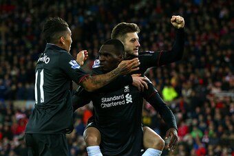 SUNDERLAND, ENGLAND - DECEMBER 30:  Christian Benteke of Liverpool celebrates with team-mates Adam Lallana and Roberto Firmino of Liverpool during the Barclays Premier League match between Sunderland and Liverpool at Stadium of Light on December 30, 2015 