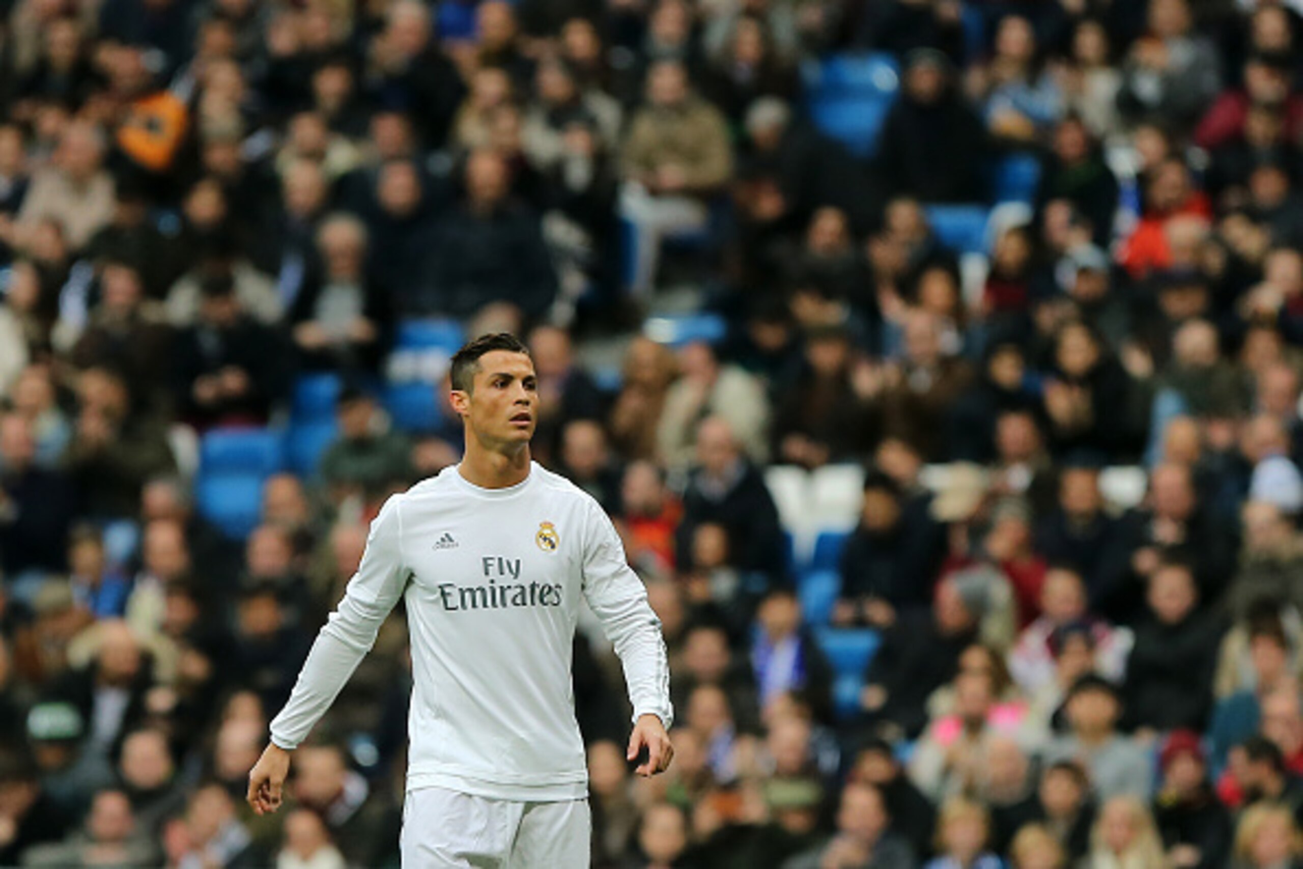 Real Madrid's Portuguese forward Cristiano Ronaldo walks on the pitch during the Spanish league football match Real Madrid CF vs Real Sociedad de Futbol at the Santiago Bernabeu stadium in Madrid on December 30, 2015.   AFP PHOTO/ CESAR MANSO / AFP / CESA