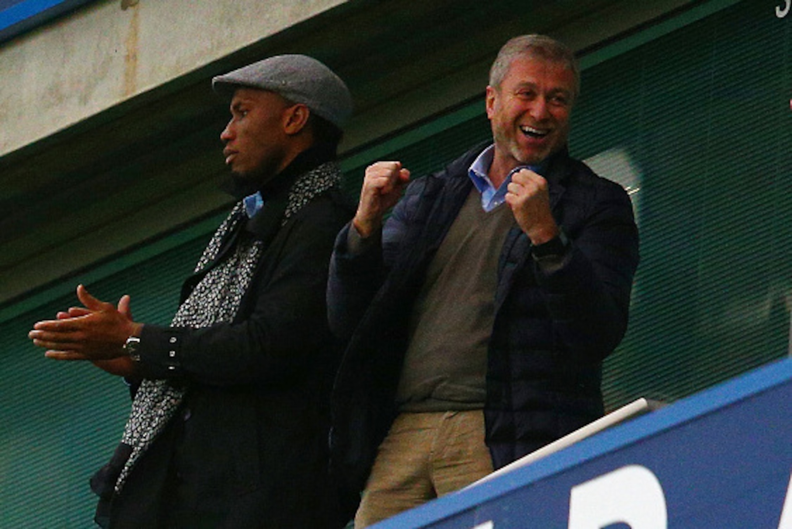 LONDON, ENGLAND - DECEMBER 19:  Didier Drogba (L) of Montreal Impact and Chelsea owner Roman Abramovich (R) celebrate Chelsea's second goal on the stand prior to the Barclays Premier League match between Chelsea and Sunderland at Stamford Bridge on Decemb