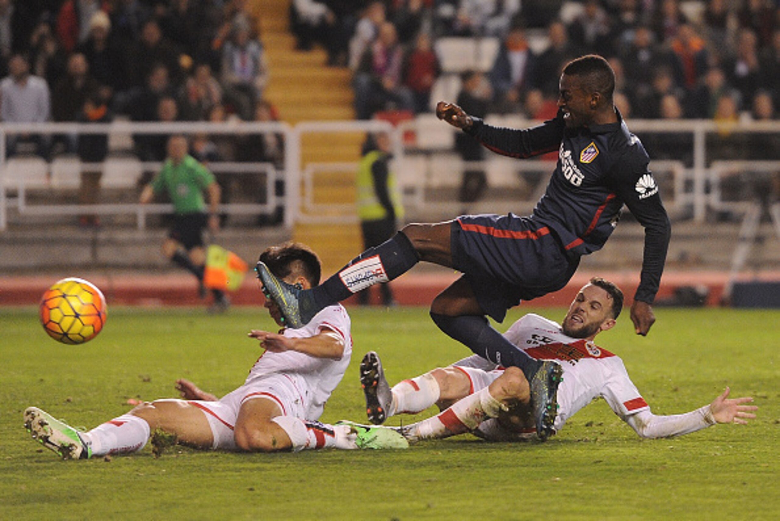 MADRID, SPAIN - DECEMBER 30:  Jackson Martinez of Club Atletico de Madrid gets his shot blocked by Zhang Chengdong of Rayo Vallecano during the La Liga match between Club Atletico de Madrid and Rayo Vallecano de Madrid at Estadio de Vallecas on December 3