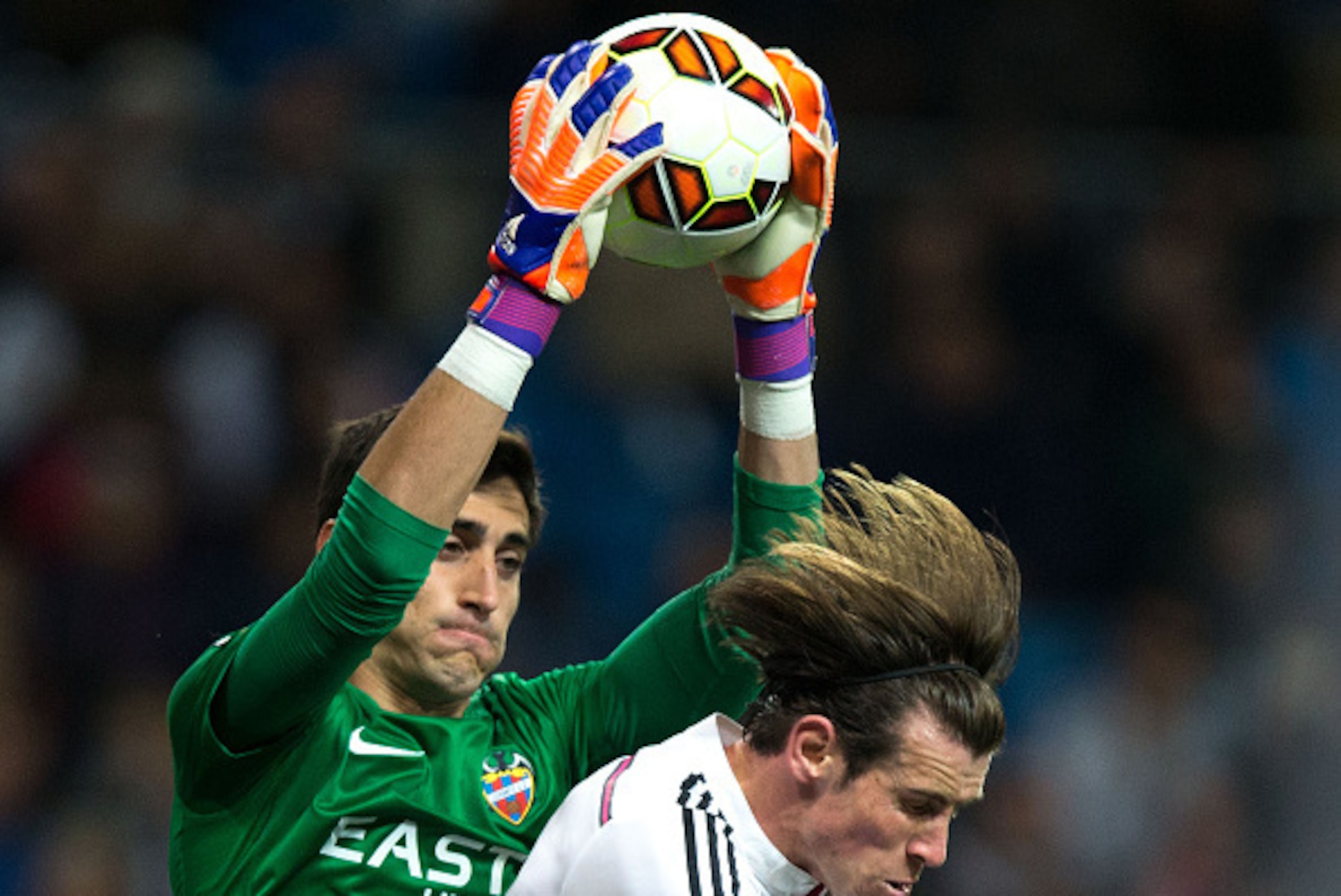 MADRID, SPAIN - MARCH 15: Goalkeeper Diego Marino (L) of Levante UD stops the ball against Gareth Bale (R) of Real Madrid CF during tha La Liga match between Real Madrid CF and Levante UD at Estadio Santiago Bernabeu on March 15, 2015 in Madrid, Spain.  (