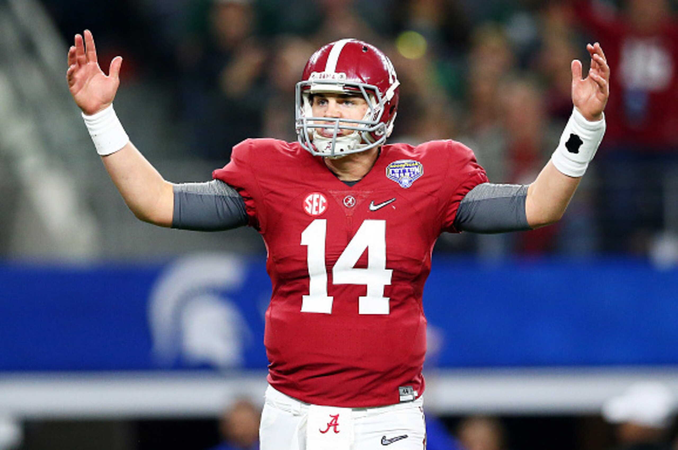 ARLINGTON, TX - DECEMBER 31:  Quarterback Jake Coker #14 of the Alabama Crimson Tide reacts after throwing a six-yard touchdown pass turnover wide receiver Calvin Ridley #3 in the third quarter against the Michigan State Spartans during the Goodyear Cotto