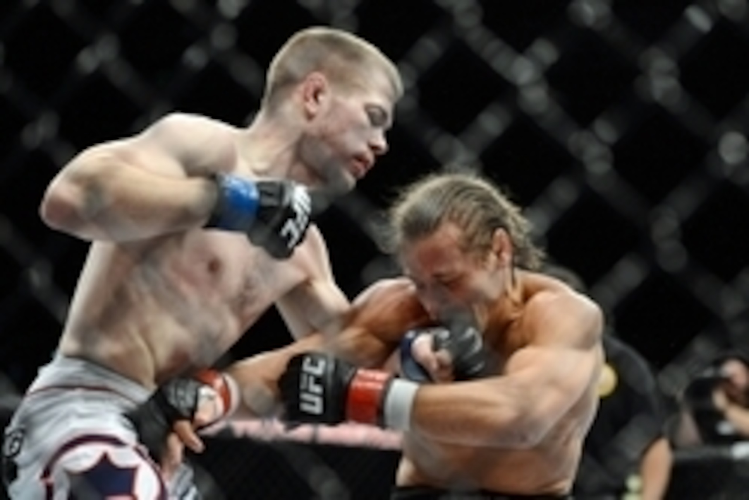 December 14, 2013; Sacramento, CA, USA; Urijah Faber (red gloves) fights Michael McDonald (blue gloves) during the bantamweight bout of the UFC on FOX 9 at Sleep Train Arena. Mandatory Credit: Kyle Terada-USA TODAY Sports