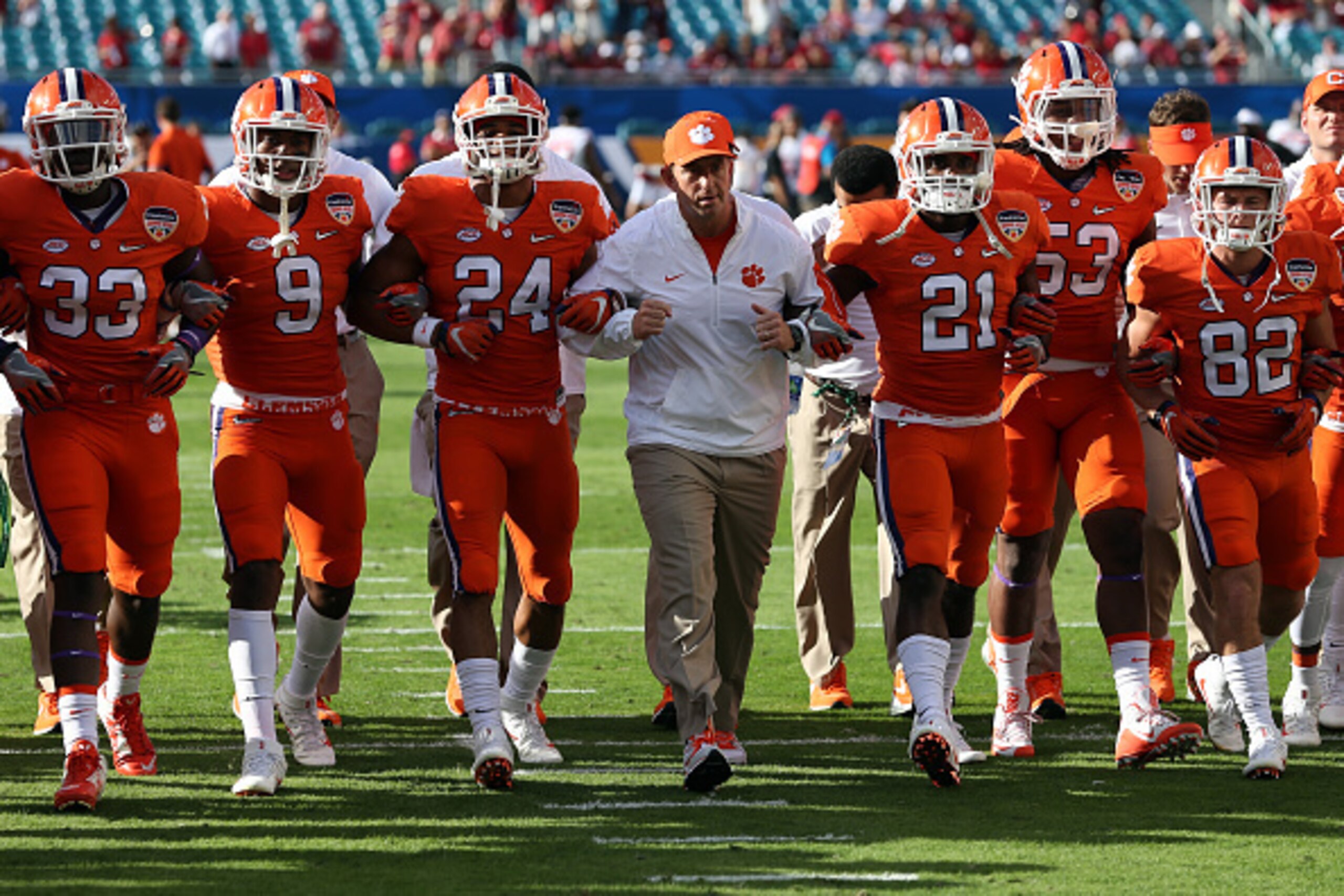 MIAMI GARDENS, FL - DECEMBER 31:  Clemson Tigers players walk on the field with head coach Dabo Swinney (C) prior to the 2015 Capital One Orange Bowl against the Oklahoma Sooners at Sun Life Stadium on December 31, 2015 in Miami Gardens, Florida.  (Photo 