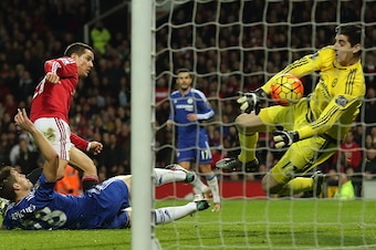 MANCHESTER, ENGLAND - DECEMBER 28:  Thibaut Courtois of Chelsea saves from Ander Herrera of Manchester United during the Barclays Premier League match between Manchester Untied and Chelsea at Old Trafford on December 28, 2015 in Manchester, England.  (Pho