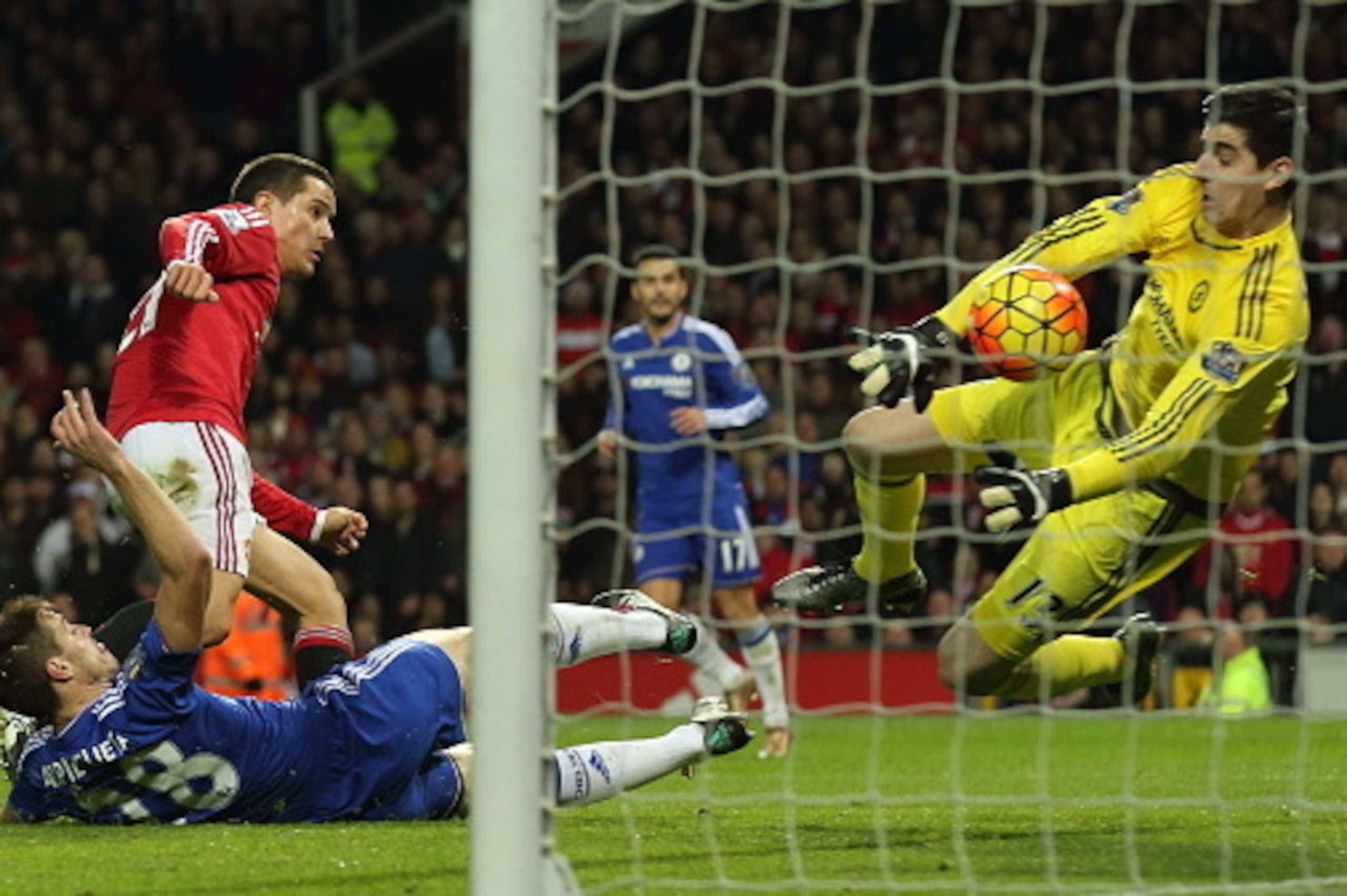 MANCHESTER, ENGLAND - DECEMBER 28:  Thibaut Courtois of Chelsea saves from Ander Herrera of Manchester United during the Barclays Premier League match between Manchester Untied and Chelsea at Old Trafford on December 28, 2015 in Manchester, England.  (Pho