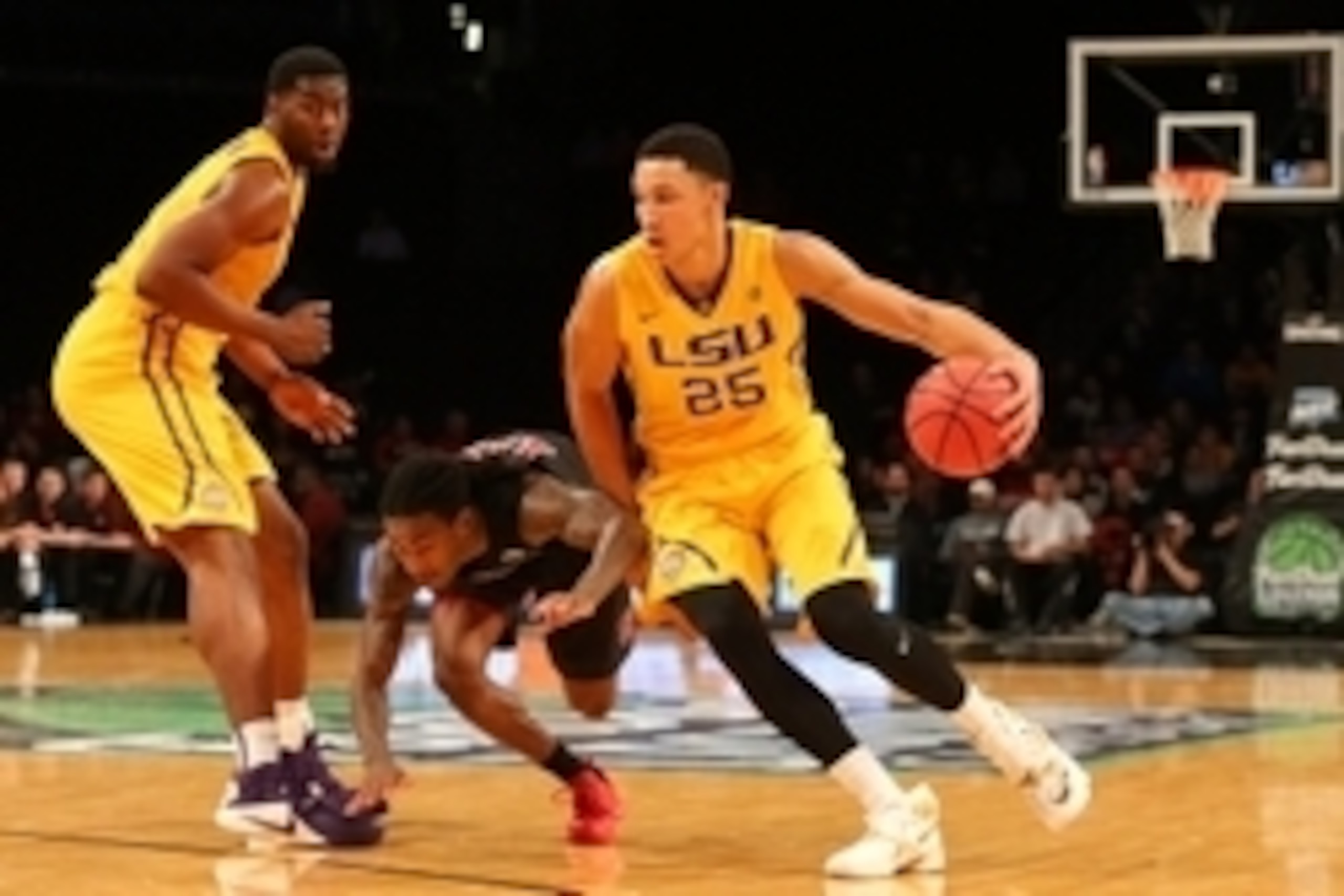 Nov 24, 2015; Brooklyn , NY, USA;  LSU Tigers forward Ben Simmons (25) drives past North Carolina State Wolfpack guard Anthony Barber (12) during the second half in the consolation game of the Legends Classic at Barclays Center. North Carolina State Wolfp