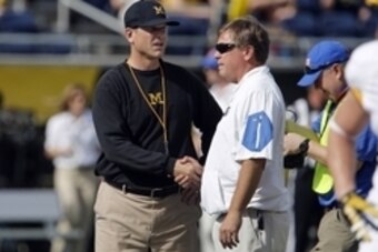 Jan 1, 2016; Orlando, FL, USA; Michigan Wolverines head coach Jim Harbaugh (left) and Florida Gators head coach Jim McElwain meet at midfield before the 2016 Citrus Bowl at Orlando Citrus Bowl Stadium. Mandatory Credit: Reinhold Matay-USA TODAY Sports