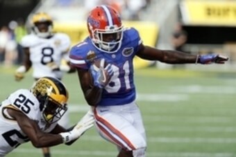 Jan 1, 2016; Orlando, FL, USA;Florida Gators wide receiver Antonio Callaway (81) runs around Michigan Wolverines safety Dymonte Thomas (25)  during the first quarter in the 2016 Citrus Bowl at Orlando Citrus Bowl Stadium. Mandatory Credit: Reinhold Matay-