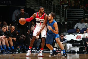 WASHINGTON, DC - JANUARY 1: John Wall #2 of the Washington Wizards defends the ball against Nikola Vucevic #9 of the Orlando Magic during the game on January 1, 2016 at Verizon Center in Washington, District of Columbia. NOTE TO USER: User expressly ackno