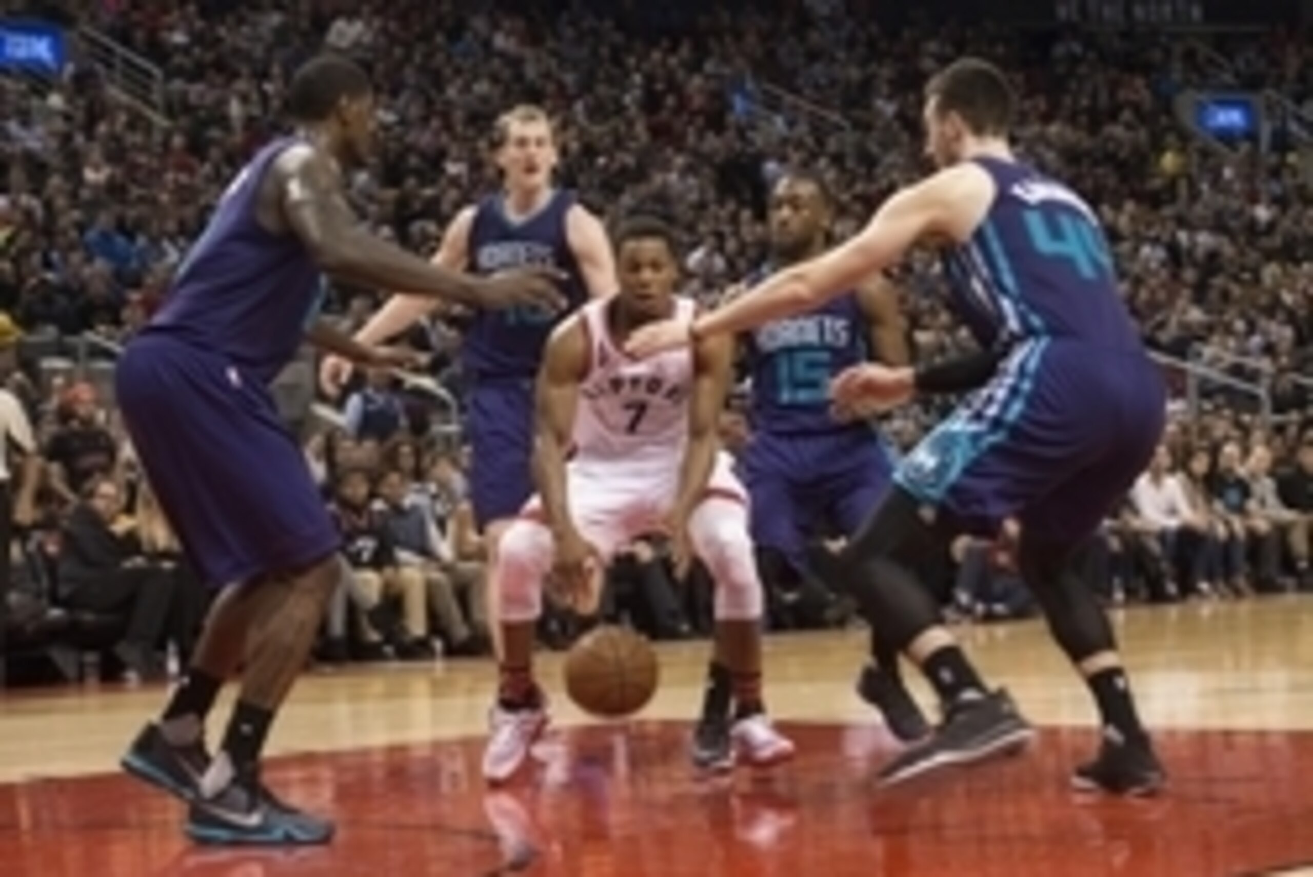 Jan 1, 2016; Toronto, Ontario, CAN; Toronto Raptors guard Kyle Lowry (7) tries to play the ball between Charlotte Hornets players including Marvin Williams (2) and Frank Kaminsky III (44) during the fourth quarter in a game at Air Canada Centre. The Toron