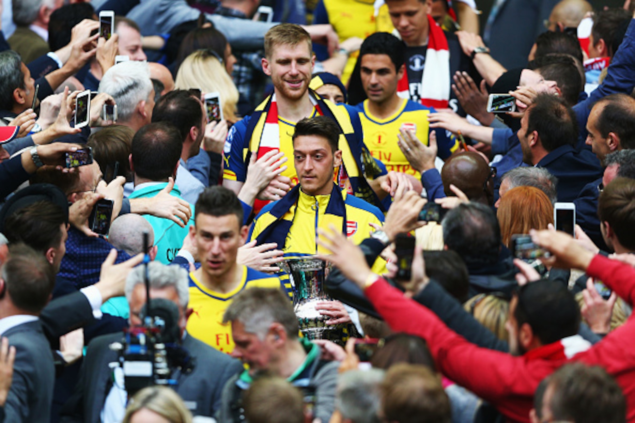 LONDON, ENGLAND - MAY 30:  Mesut Oezil of Arsenal with his winners medal following the FA Cup Final between Aston Villa and Arsenal at Wembley Stadium on May 30, 2015 in London, England.  (Photo by Paul Gilham/Getty Images)