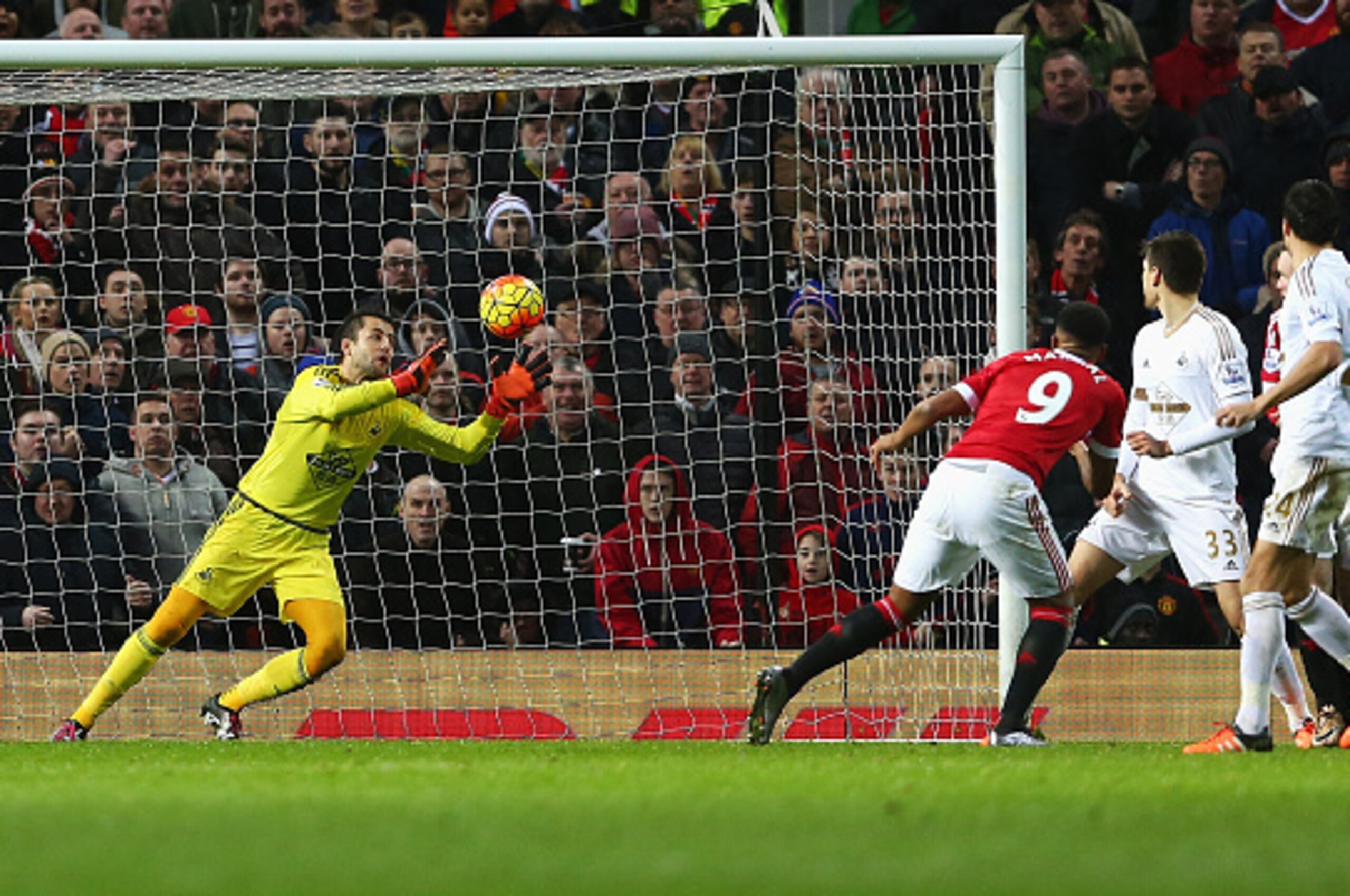 MANCHESTER, ENGLAND - JANUARY 02:  Anthony Martial (2nd L) of Manchester United heads the ball to score his team's first goal past Lukasz Fabianski (1st L) of Swansea City during the Barclays Premier League match between Manchester United and Swansea City