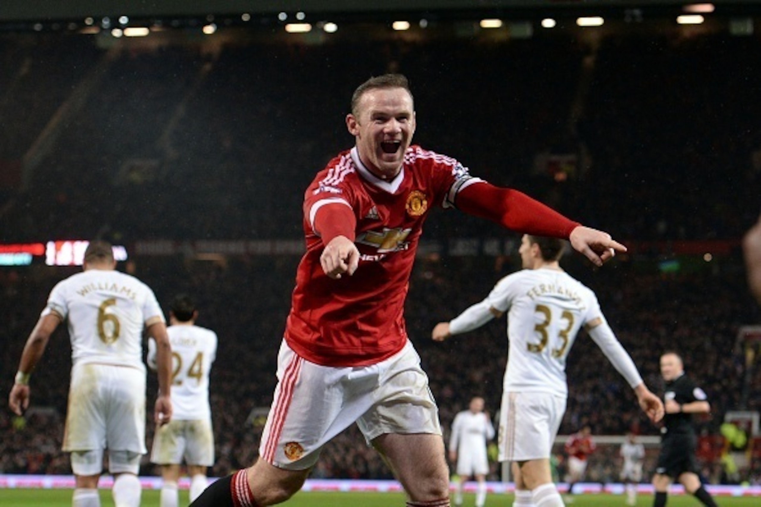 Manchester United's English striker Wayne Rooney celebrates scoring his team's second goal during the English Premier League football match between Manchester United and Swansea City at Old Trafford in Manchester, north west England, on January 2, 2016. A