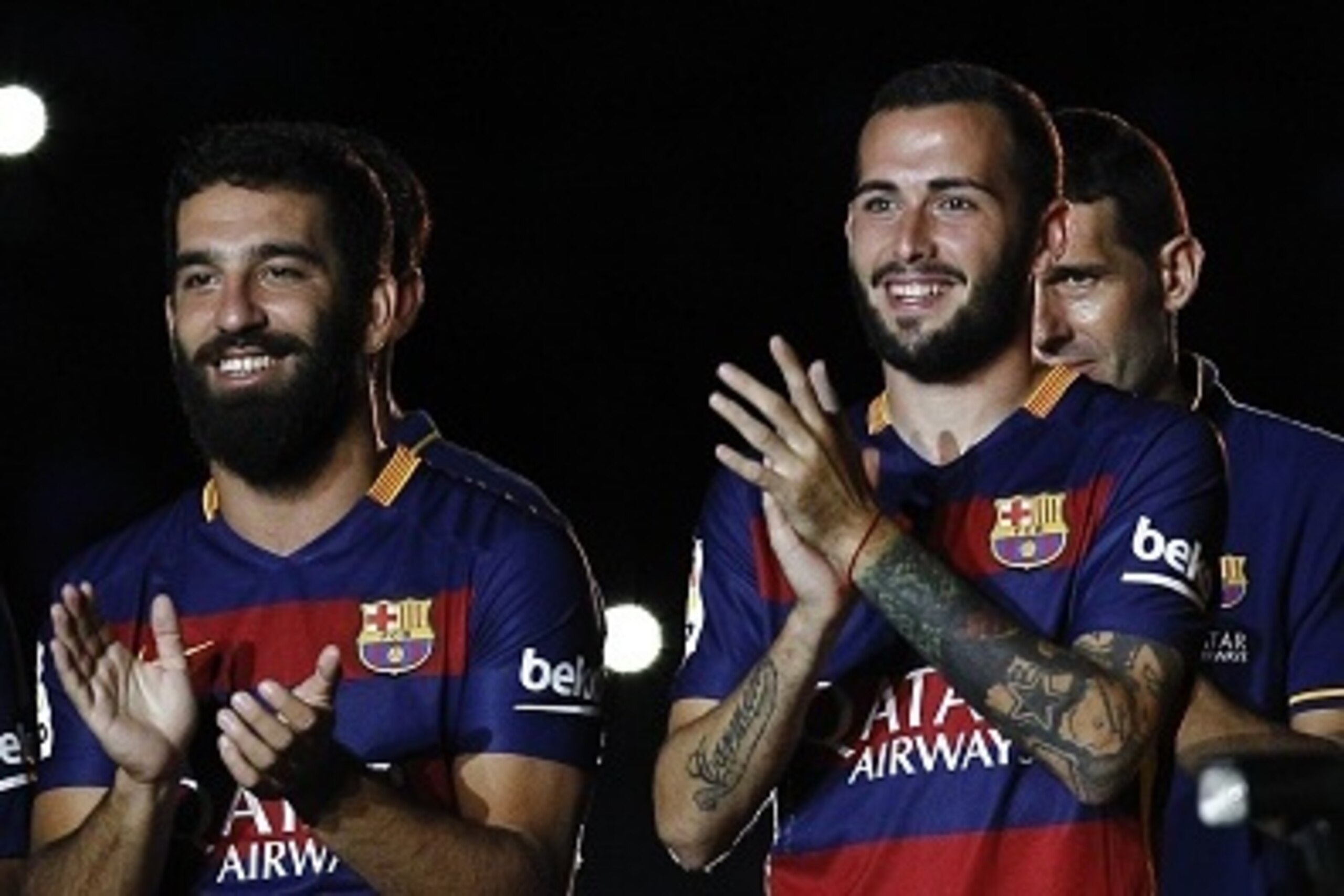 Barcelona's Turkish midfielder Arda Turan (L) and Barcelona's defender Aleix Vidal (R) stand during an official team presentation at the 50th Joan Gamper Trophy football match FC Barcelona vs AS Roma at the Camp Nou stadium in Barcelona on August 5, 2015.