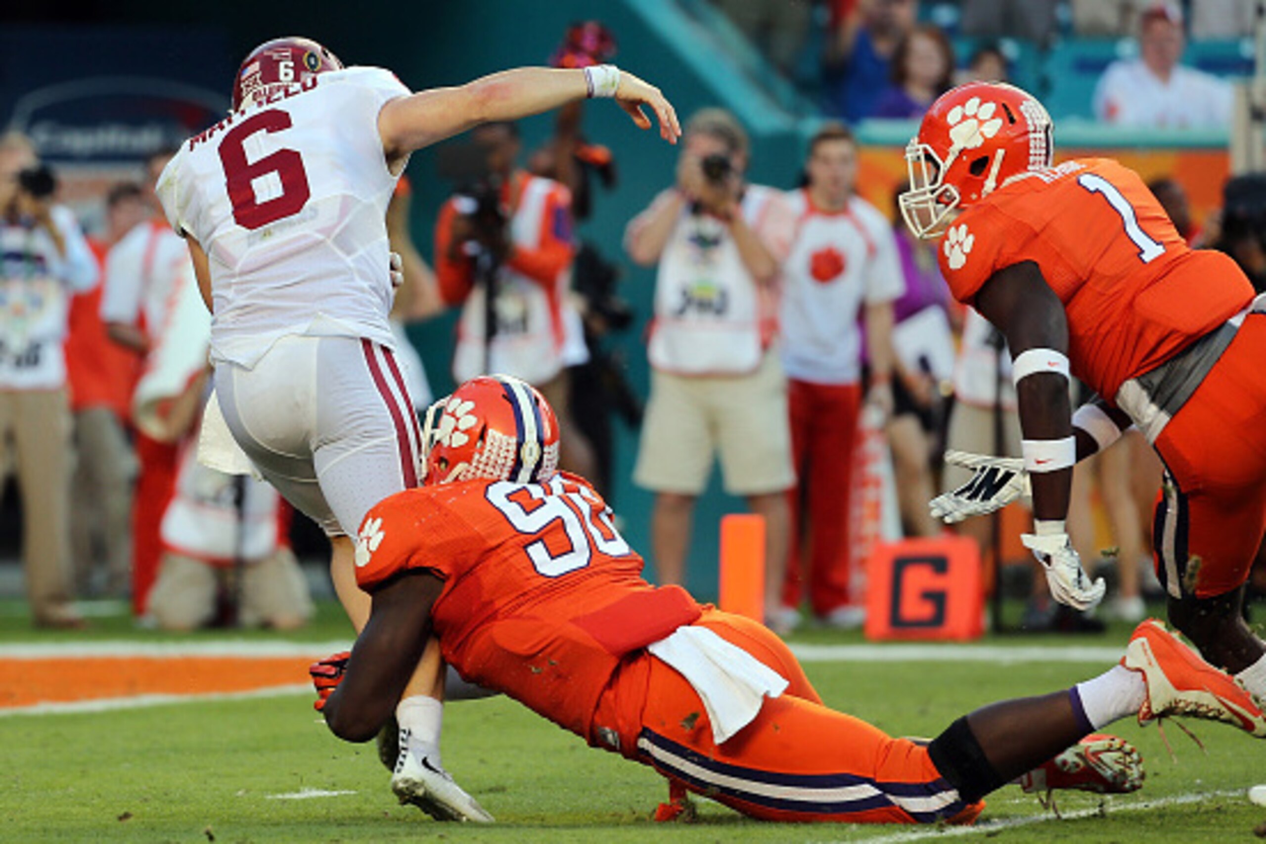 MIAMI GARDENS, FL - DECEMBER 31:  Baker Mayfield #6 of the Oklahoma Sooners is sacked by Shaq Lawson #90 of the Clemson Tigers in the first quarter during the 2015 Capital One Orange Bowl at Sun Life Stadium on December 31, 2015 in Miami Gardens, Florida.