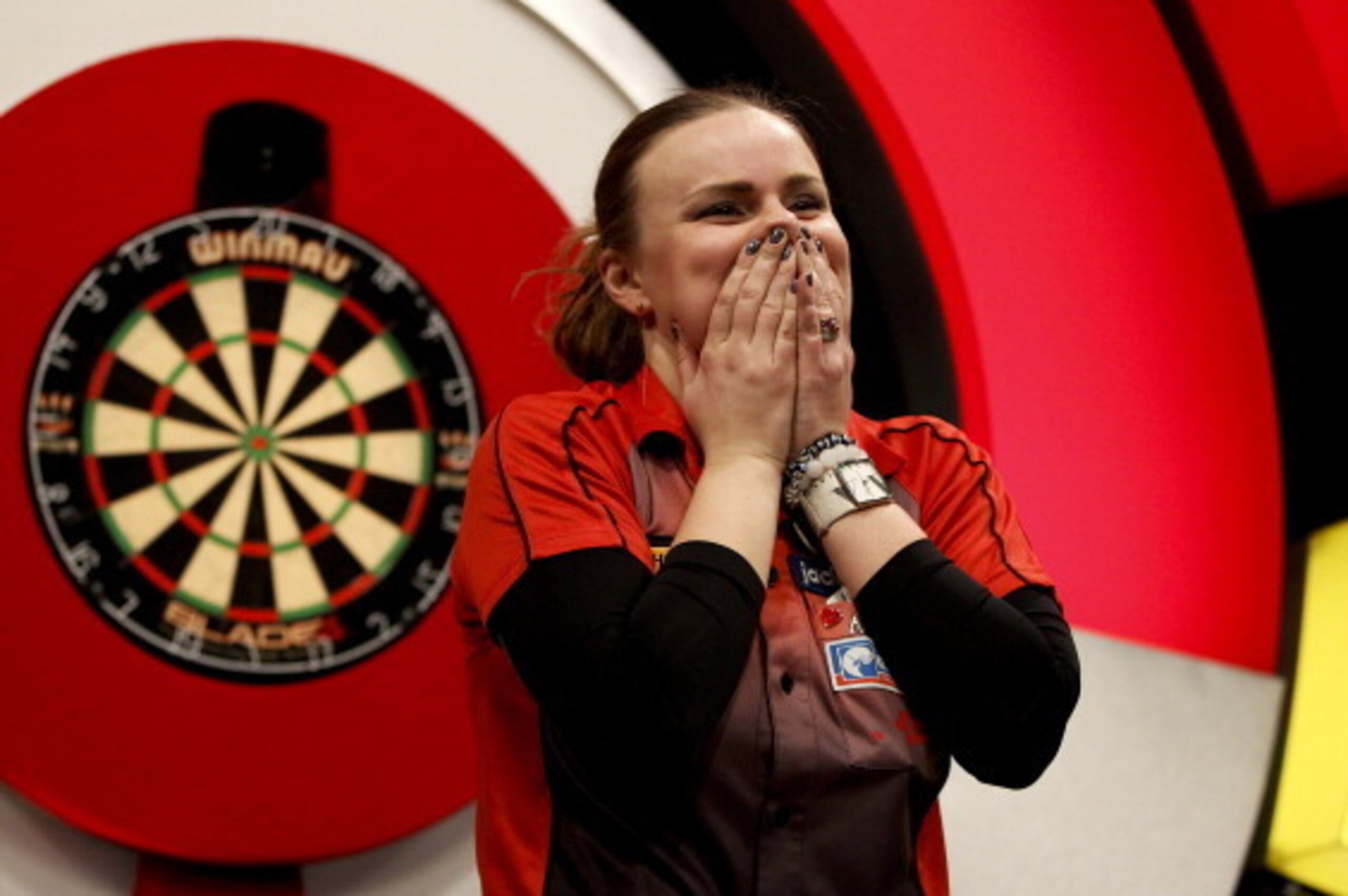 FRIMLEY, ENGLAND - JANUARY 12: Anastasia Dobromyslova of Russia reacts after winning the women's final on day eight of the BDO Lakeside World Professional Darts Championships at the Lakeside Country Club on January 12, 2013 in Frimley, England. (Photo by 