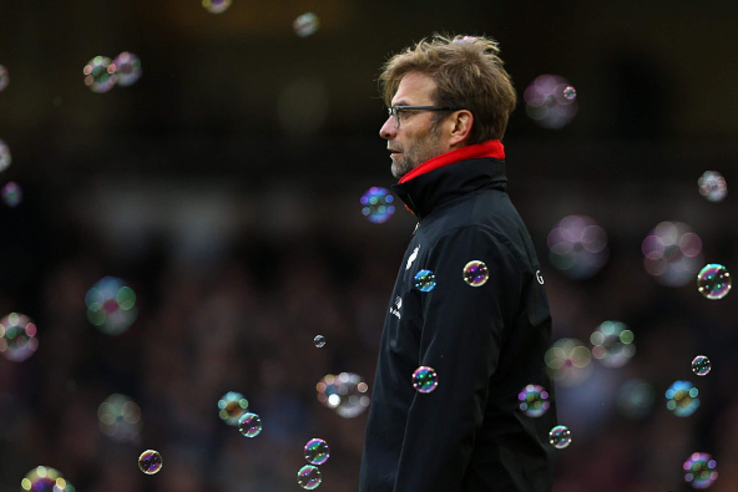 Liverpool's German manager Jurgen Klopp watches through the bubbles during the English Premier League football match between West Ham United and Liverpool at The Boleyn Ground in Upton Park, East London on January 2, 2016. West Ham won the game 2-0. AFP P